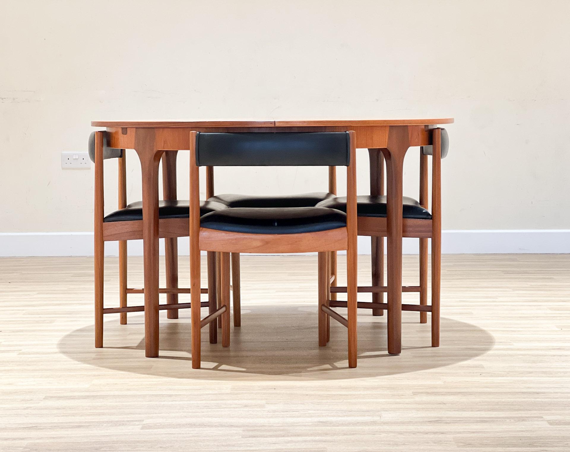 Set of an extendable circular table and 4 chairs from the Scottish firm A.H. McIntosh & Co., created by Tom Robertson.


This set was designed in the 70s. The table (model T21) is constructed with solid teak legs and teak veneered tabletop.

It