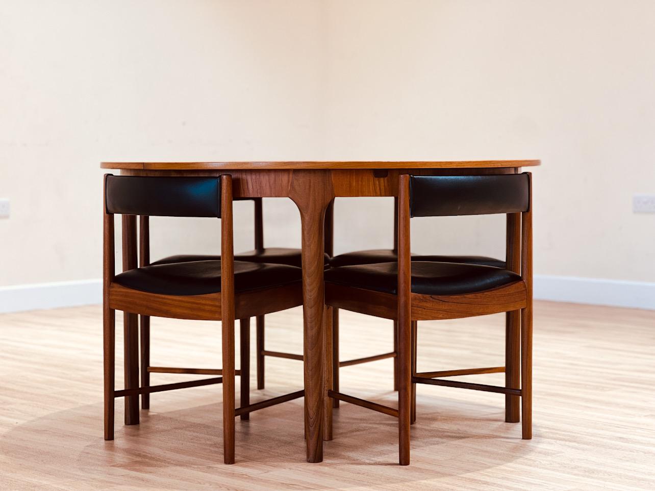 Set of an extendable circular table and four chairs from the Scottish firm A.H. McIntosh & Co., created by Tom Robertson.

This unique set, designed in the 1970s, features a table (model T21) with  solid teak legs and a teak design that stands out