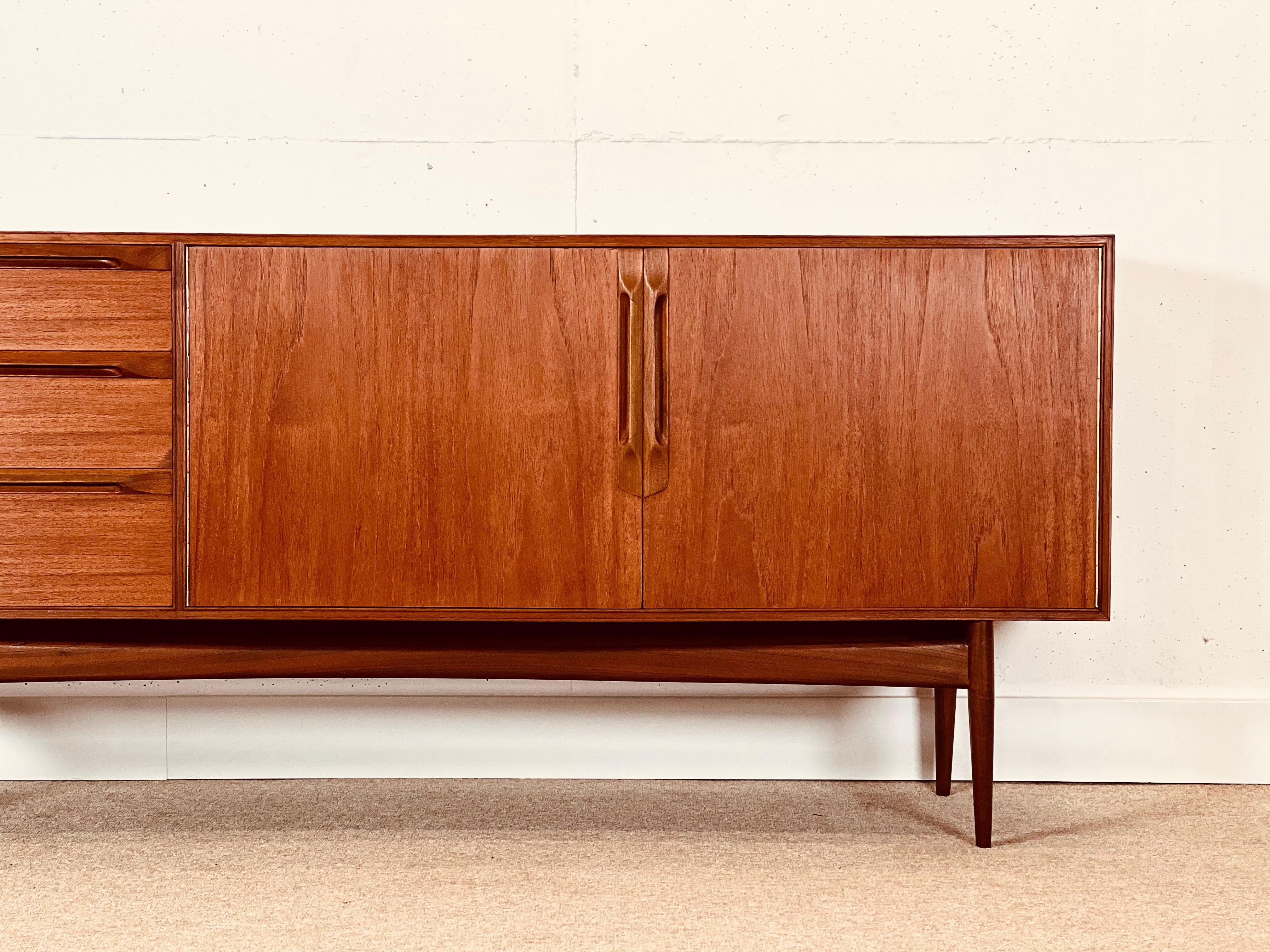 Fascinating creation of Tom Robertson, the Scottish firm A.H. McIntosh manufactured in the early ’70s under the name Eden.

The structure is in high-quality laminated teak wood.

The front features three drawers (the upper one with compartments for