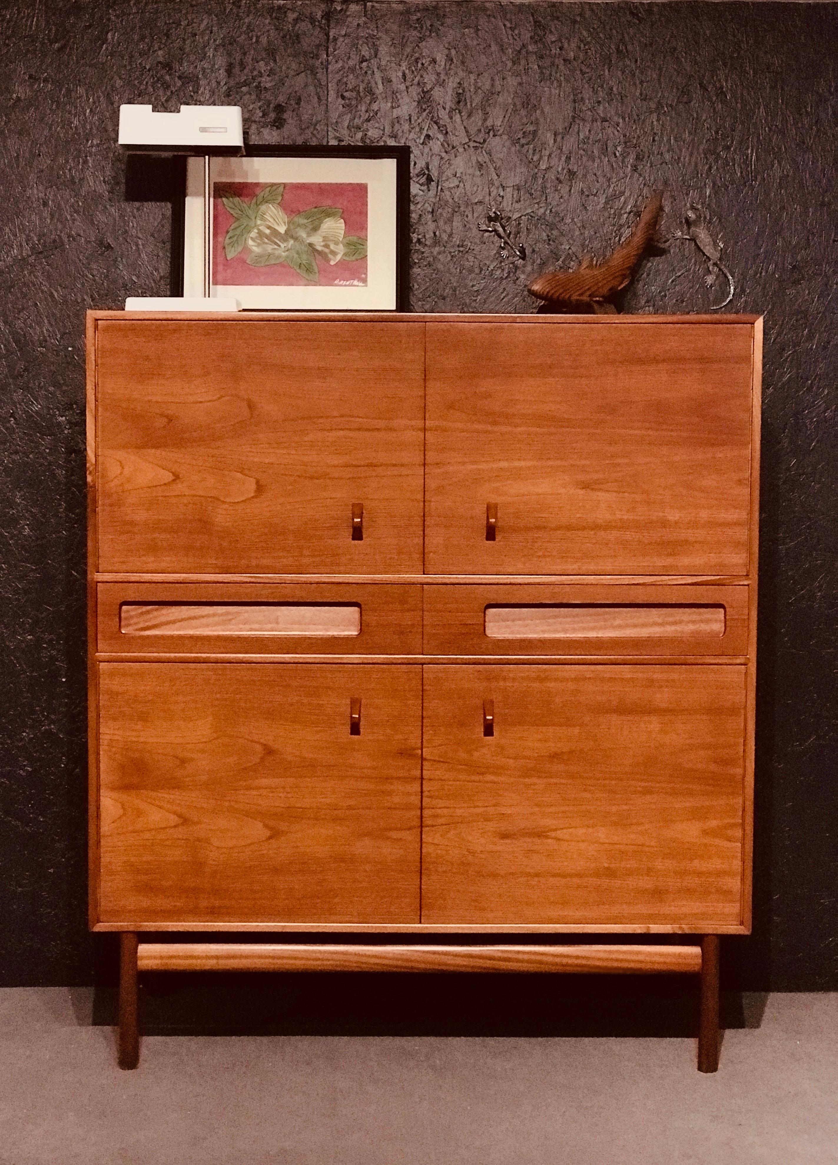 Tom Robertson designed this sideboard in the early ’70s for the well-known brand A.H. McIntosh in Scotland. This time, Tom Robertson made a taller sideboard—this beautiful cabinet with four cupboards and two teakwood drawers. The sideboard has four