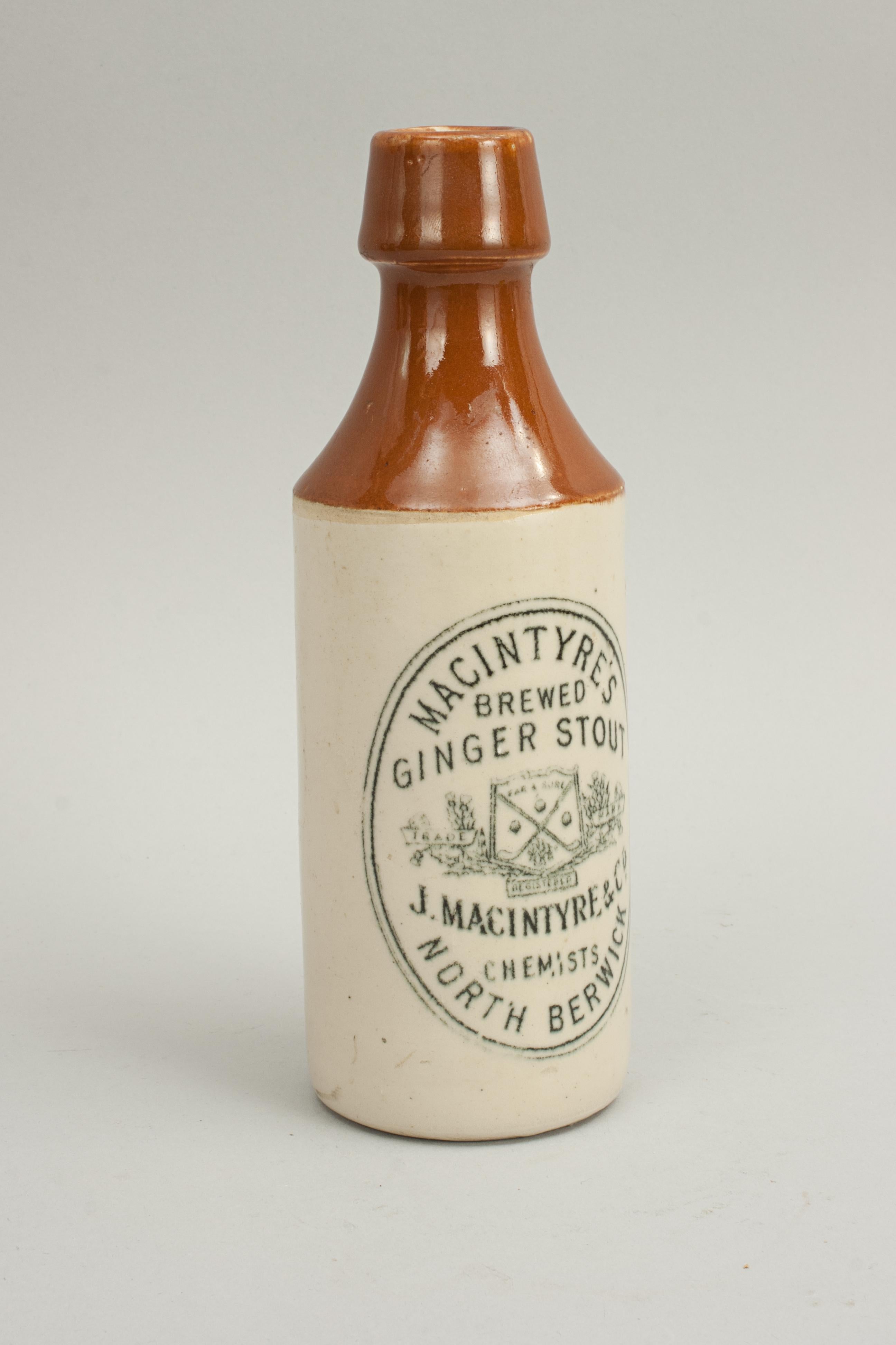 J. Macintyre & Co. Ginger Stout beer bottle.
A good example of a J. McIntyre & Co. of North Berwick Ginger Beer glazed stone ware bottle. The front of the bottle decorated 'Macintyre's Brewed Ginger Stout, J. Macintyre & Co. Chemists, North