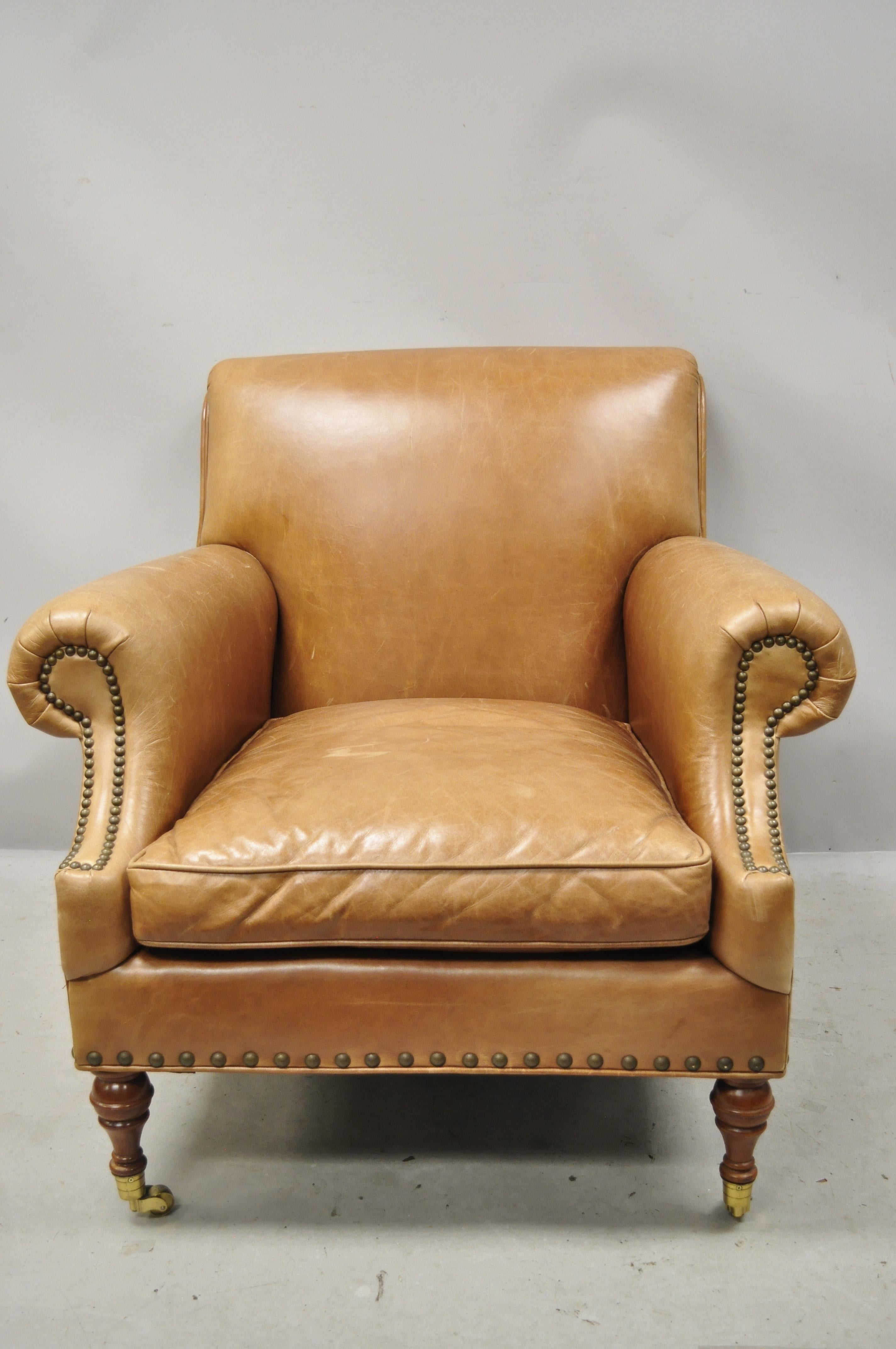 20th century McKinley leather English Regency cigar camel leather club lounge chair and ottoman. Item features brown/tan camel leather upholstery, nailhead trim, rolled arms and back, brass rolling casters, solid wood construction, original label,