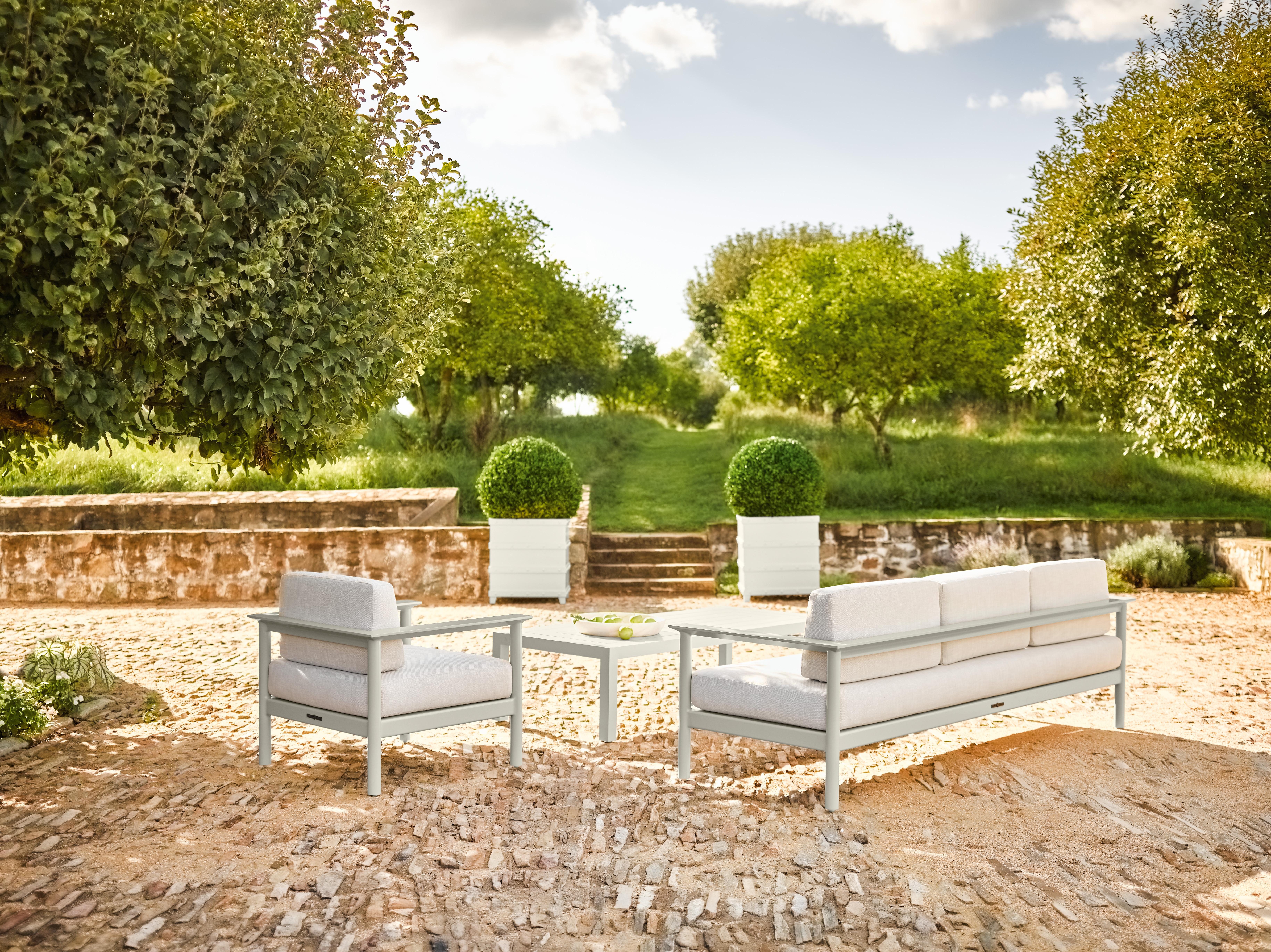 McKinnon and Harris Couper Three-Seater Sofa in Gywnn's Island Grey. High performance outdoor aluminum furniture for estate, garden, and yacht. The sofa version of our unofficial drinks chair, with arms wide and flat enough to hold a libation. We