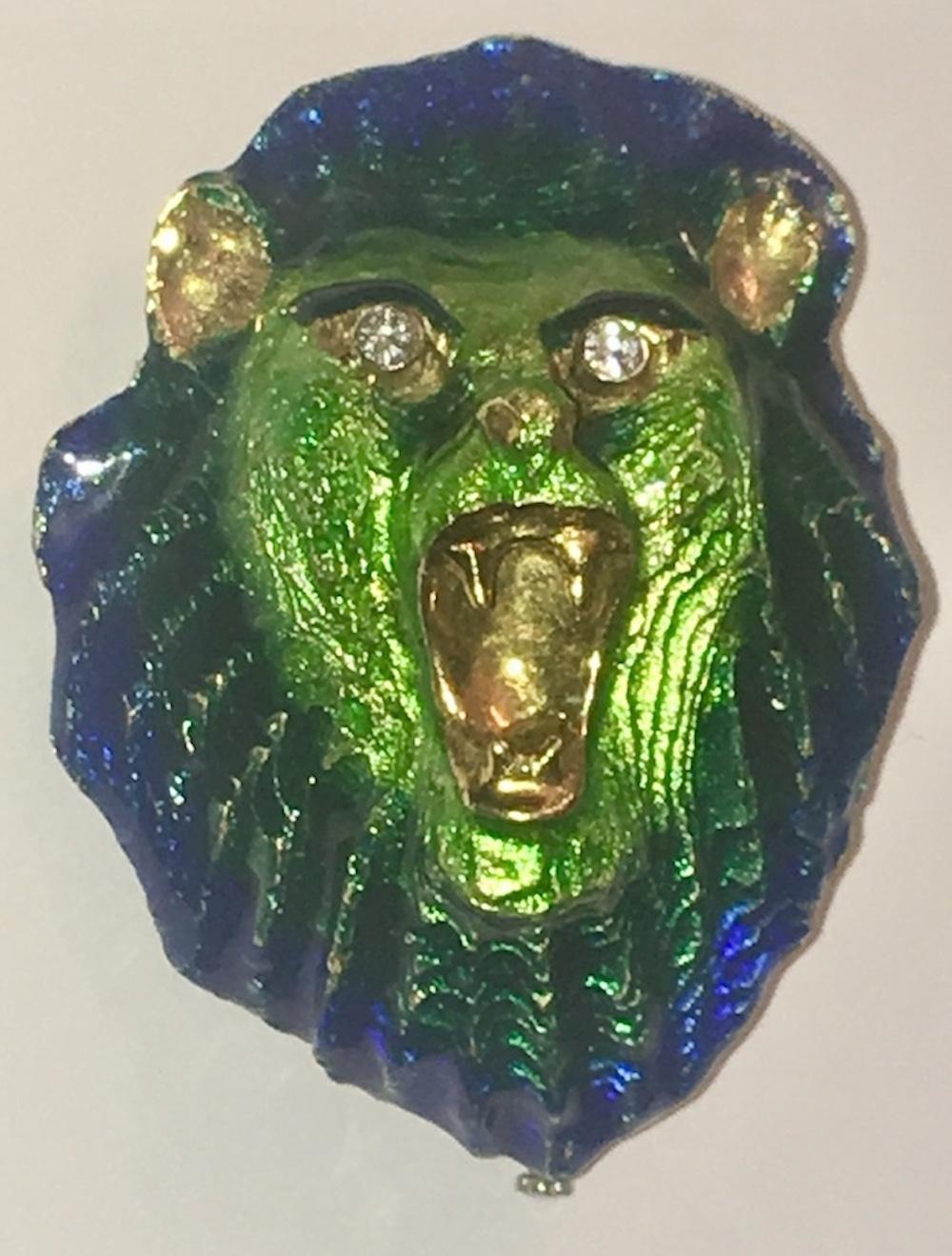 Blue and Green enamel lion head pin with diamond eyes. Marked, MCM 18 kt Italy, Measures 2.25” by 1.75” wide. 1950s Weighs, 48.2 grams
