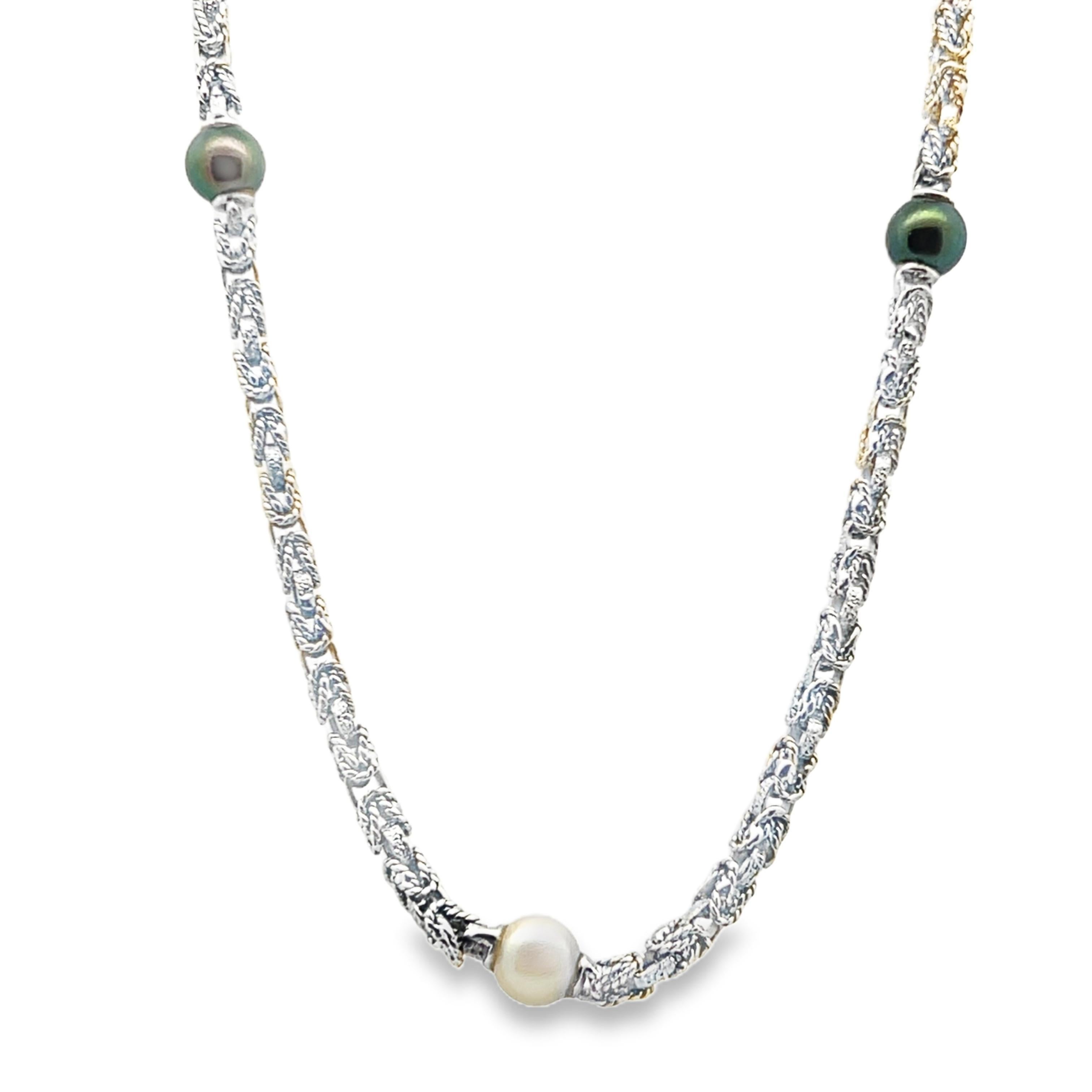 This lovely Mid Century Modern necklace features a beautifully detailed 18k white gold Byzantine chain combined with Akoya and Tahitian pearls. The Akoya and Tahitian pearls are black and white in color, and they are strung in a juxtaposition
