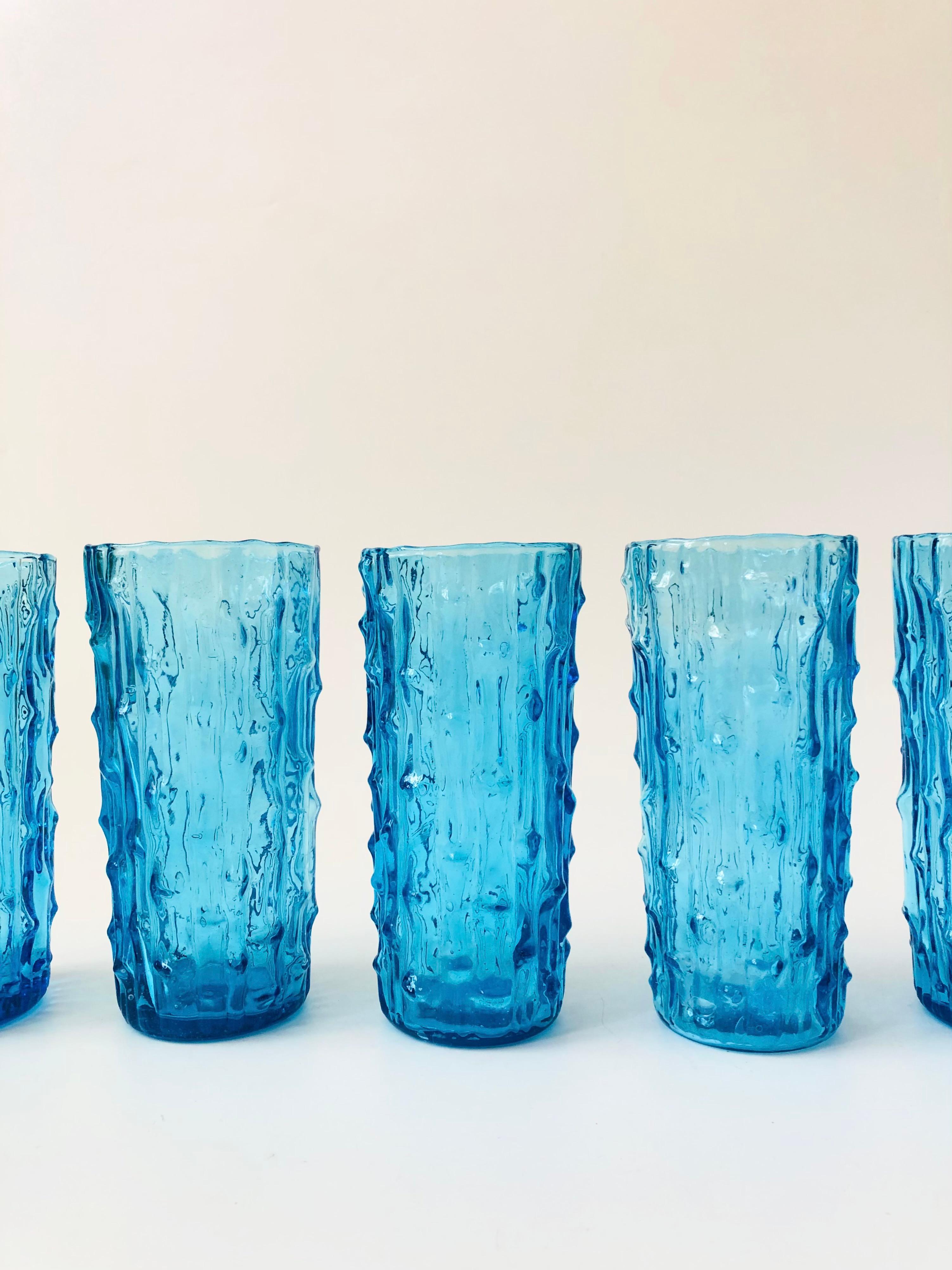 A set of 6 mid century highball glasses in textured vibrant blue colored glass. Made by Anchor Hocking in the 