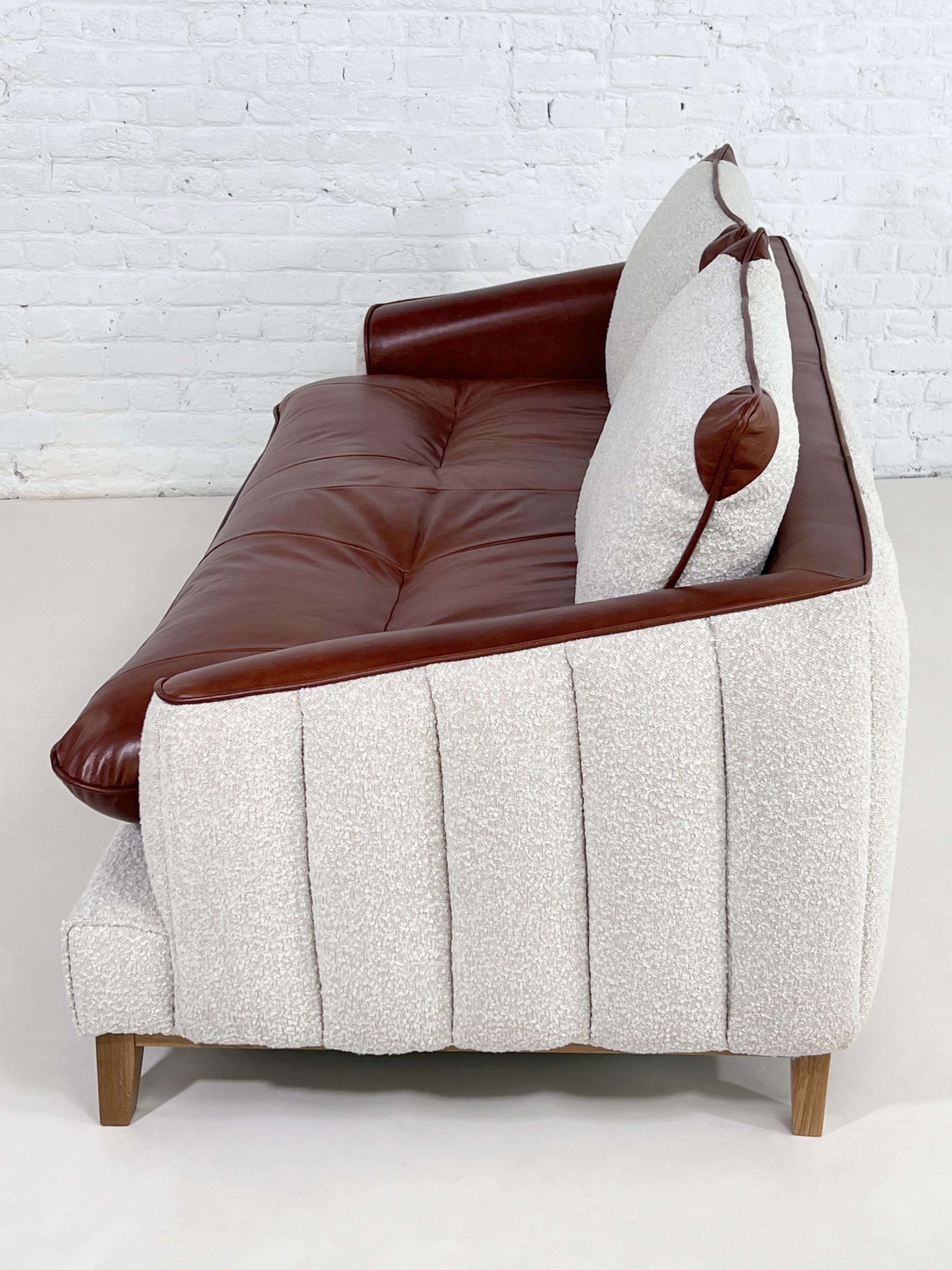 MCM And Scandinavian Design Style Cognac Leather And Beige Bouclé Fabric Sofa with Wooden Base Finishes.
