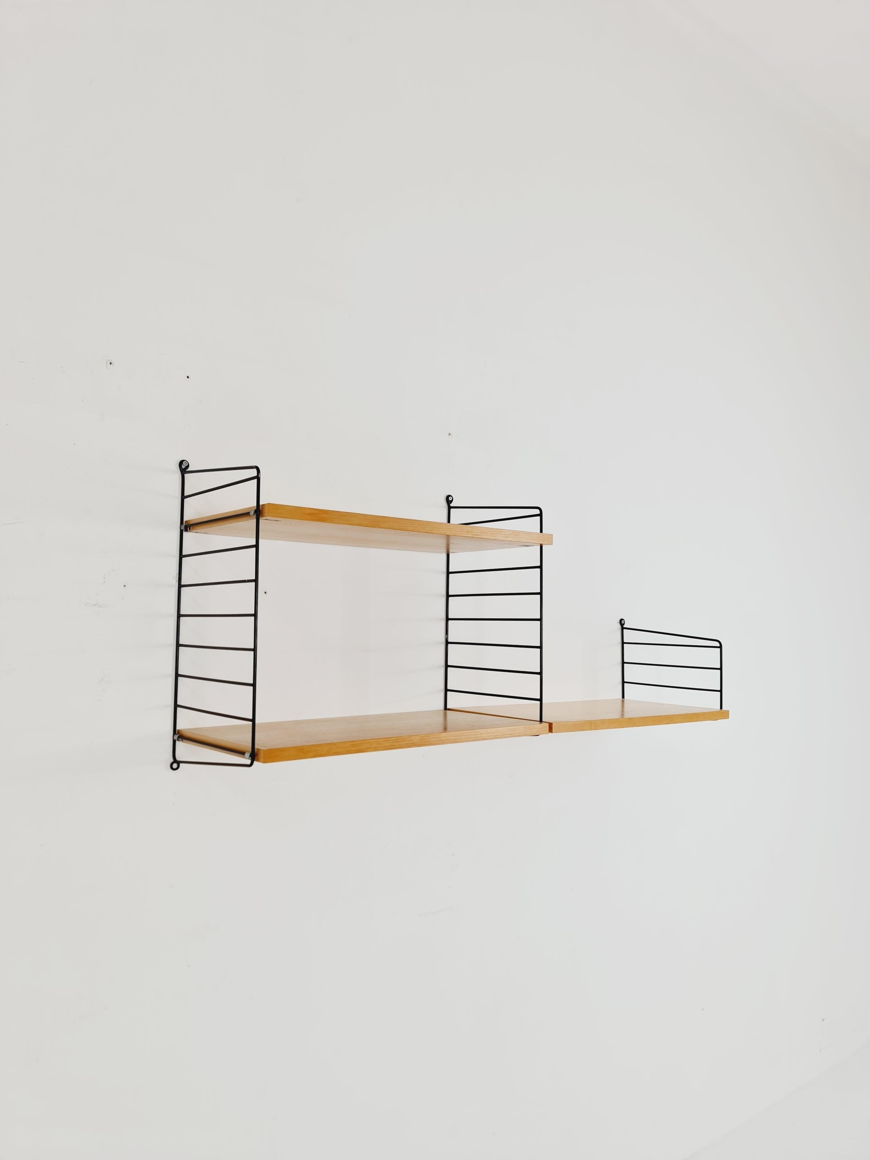 Original MCM Ash shelving system - consists of Black lacquered metal ladders, from string Stockholm 1960s

The respective elements are made of Ash (veneer). In addition to shelves, lockable compartments, and space for books, 

Dimensions:

In total: