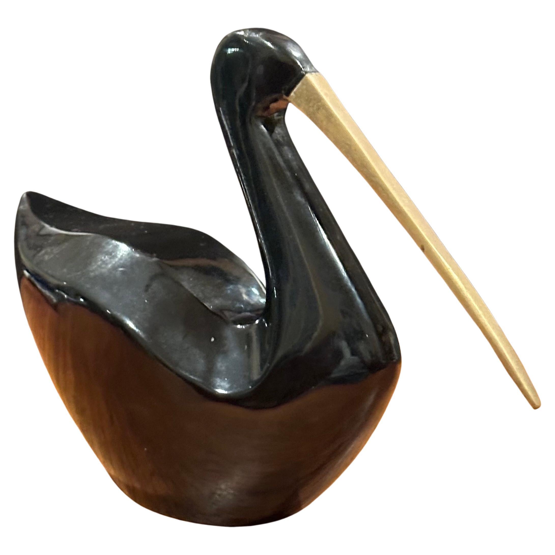 Beautiful MCM bakelite black bird with brass beak by Rosenthal Netter, circa 1960s.  Cool piece in very good vintage condition that measures 9.5