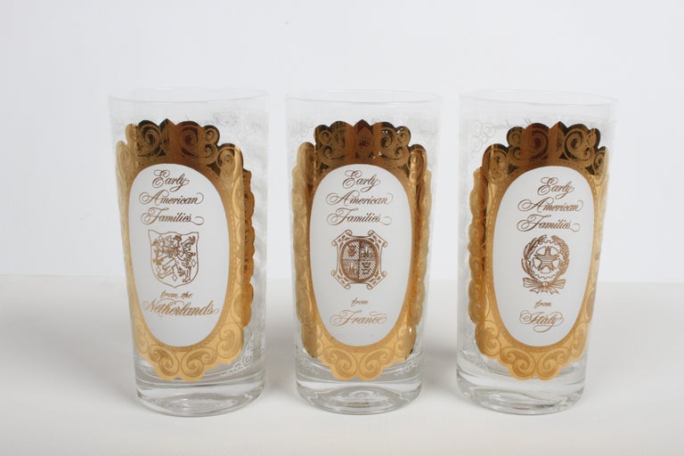 1960s MCM barware set of 8, 22k gilt & white highball glasses, with Early American Families names and countries crest gold over white. List of names from Spain, France, Sweden, Italy, Netherlands and Germany on the back of each glass. Example of