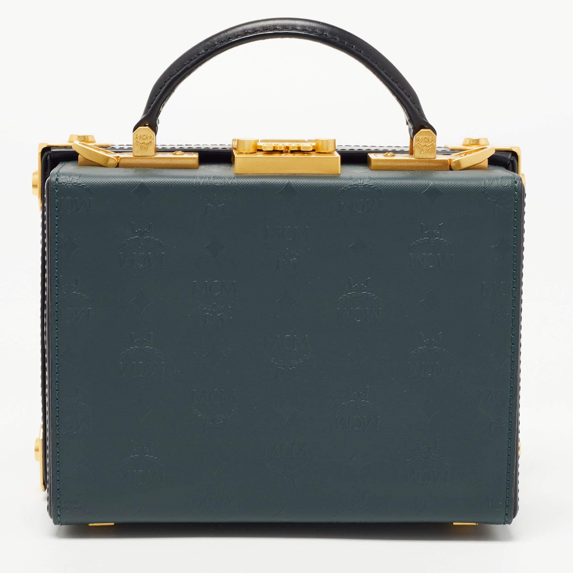 This pretty bag from MCM is a treat to our eyes! The box-shaped bag is made from coated canvas & leather and is decorated with striking gold-tone accents. In addition to the top handle, the bag comes with a detachable shoulder strap for ease of