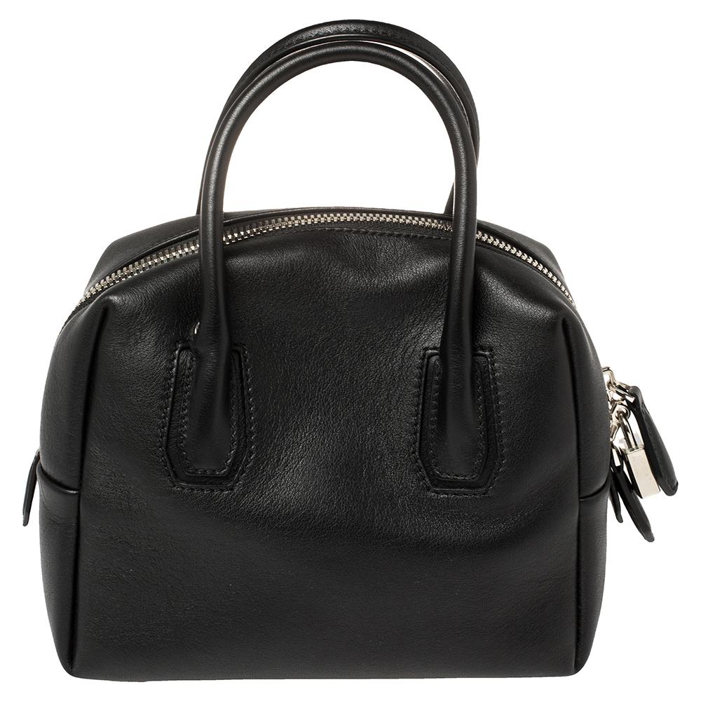 Add a touch of sophistication to your outfit with this MCM's Boston satchel adorned in a black shade. Skillfully made from leather with two top handles, the well-sized interior can easily hold more than just essentials. This creation comes with a