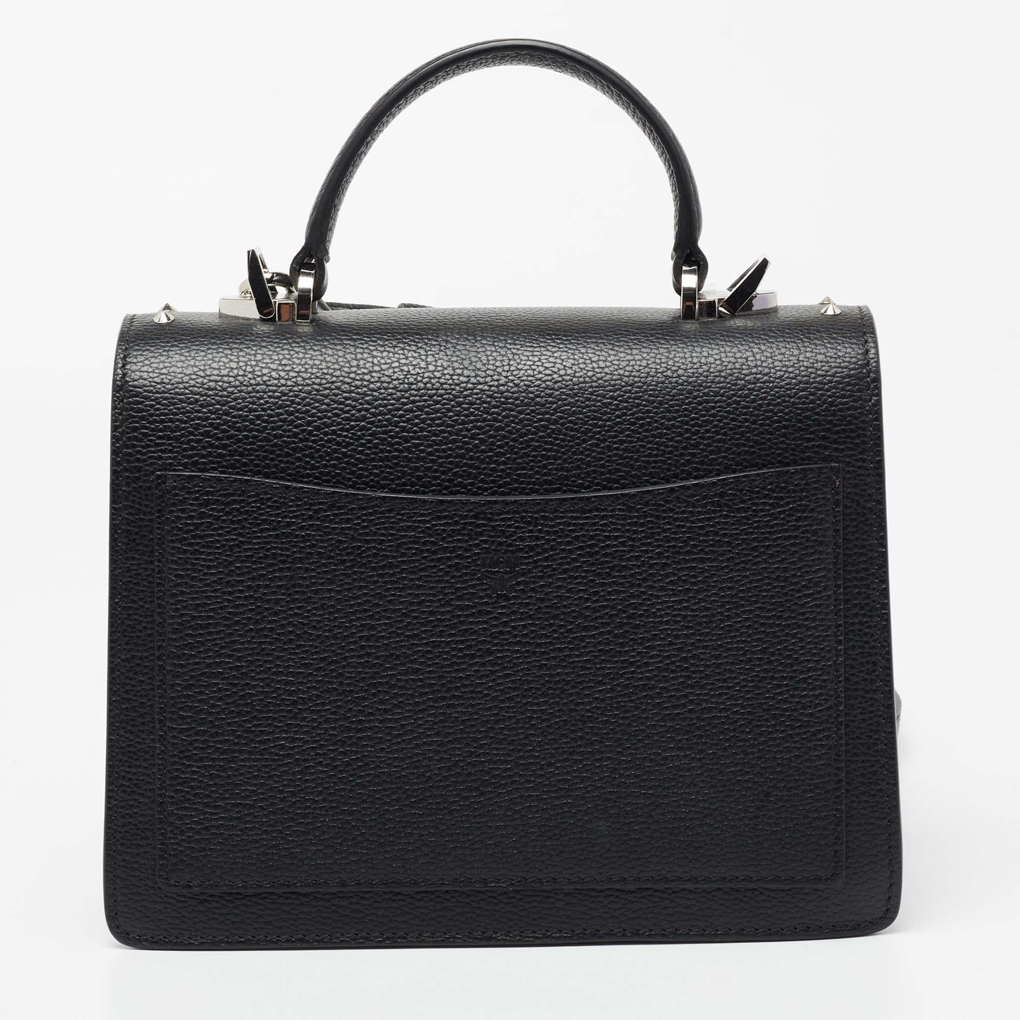 This Patricia bag from the House of MCM exudes the right amount of class and style. Crafted from black leather, this bag is adorned with a top handle and silver-tone hardware. It accommodates a spacious interior. Make this classy MCM bag yours today