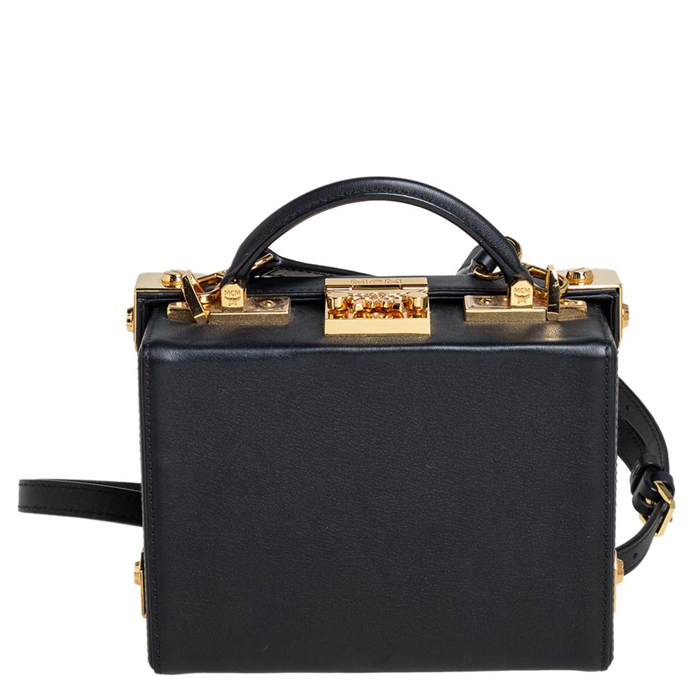 Make a statement every time you step out with this stylish Berlin Box bag from MCM. Crafted from black leather, it features a boxy shape with gold-tone metal corners and stud embellishments on the front. The creation comes with a top handle and a