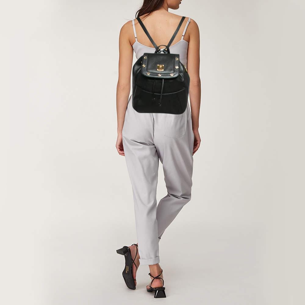 Marked by flawless craftsmanship and enduring appeal  this MCM black backpack is bound to be a versatile and durable accessory. It has a practical size.