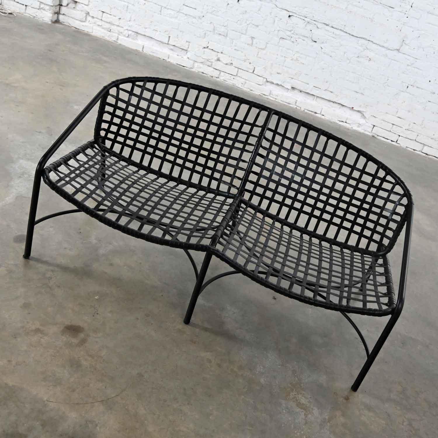 Beautiful vintage Mid-Century Modern black vinyl webbing & black powder coated aluminum frame settee attributed to Brown Jordan for the Kantan Collection by Tadao Inouye. Gorgeous condition, keeping in mind that this is vintage and not new so will