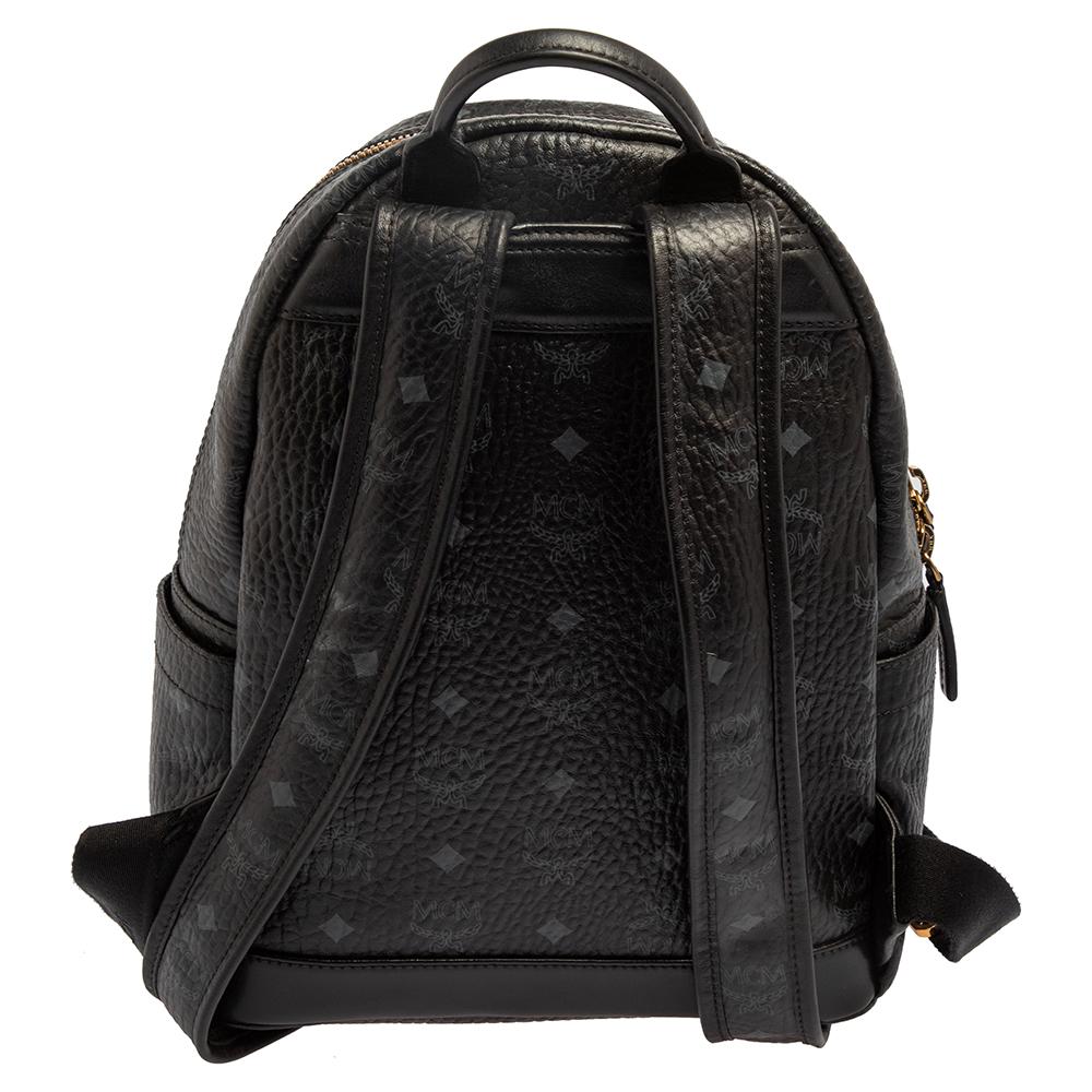 This stunning MCM backpack will come in handy for daily use or as a style statement. It is crafted from Visetos coated canvas and leather, embellished with studs, and equipped with a front pocket and a spacious interior secured by a zipper. Two