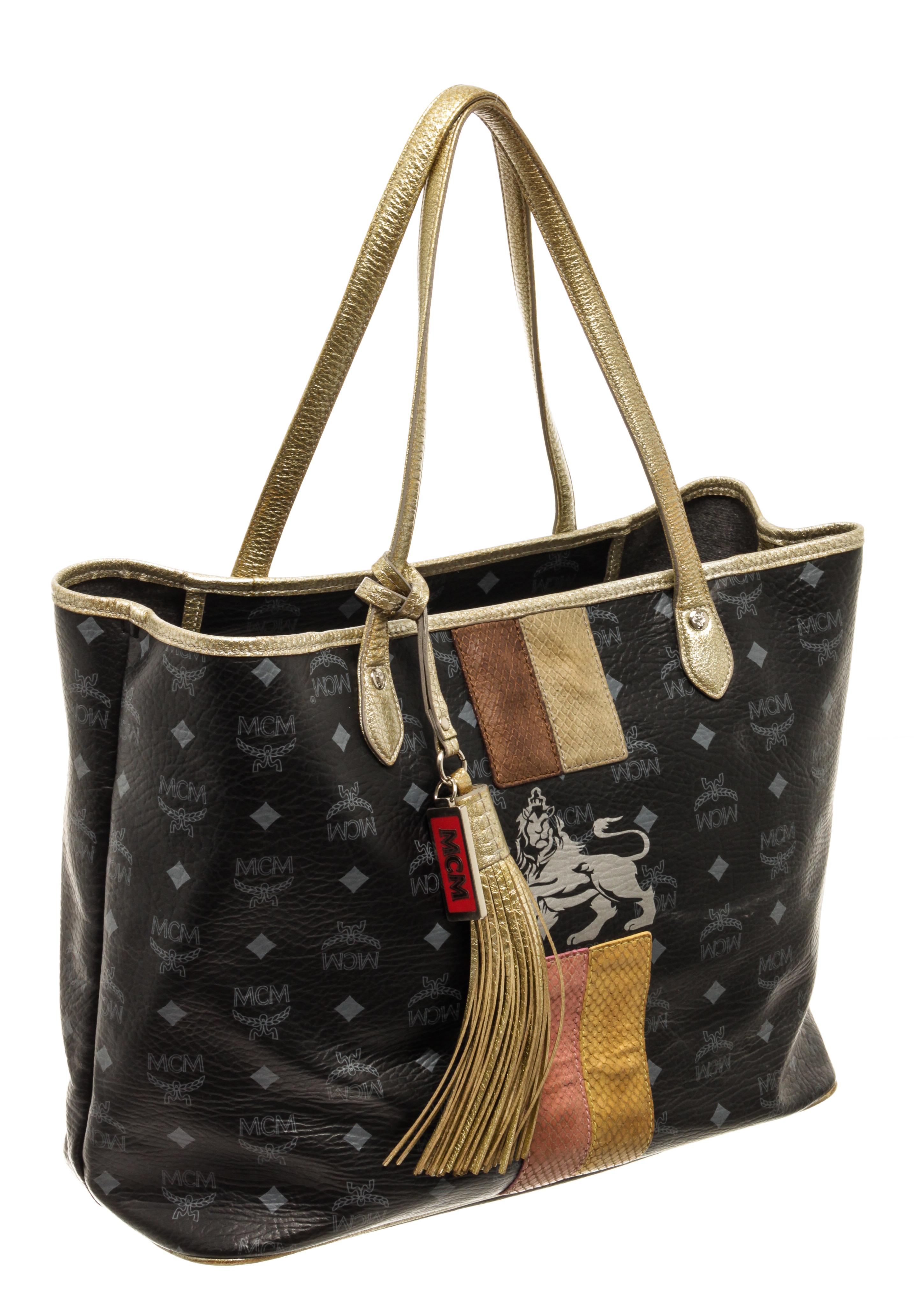MCM Black Visetos Lion Shopper Tote Bag with silver-tone hardware, dual shoulder straps, leather trim embellishment, unlined & dual interior pockets, clasp closure at top

440299MSC