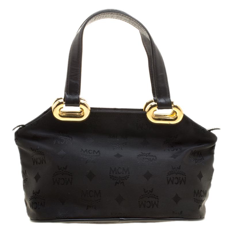 This creation from MCM has a modern design with a nylon exterior covered in their logo and a nylon interior to safely carry the things you cannot do without. Held by two top handles, this black tote is perfectly styled to win hearts.

Includes: The