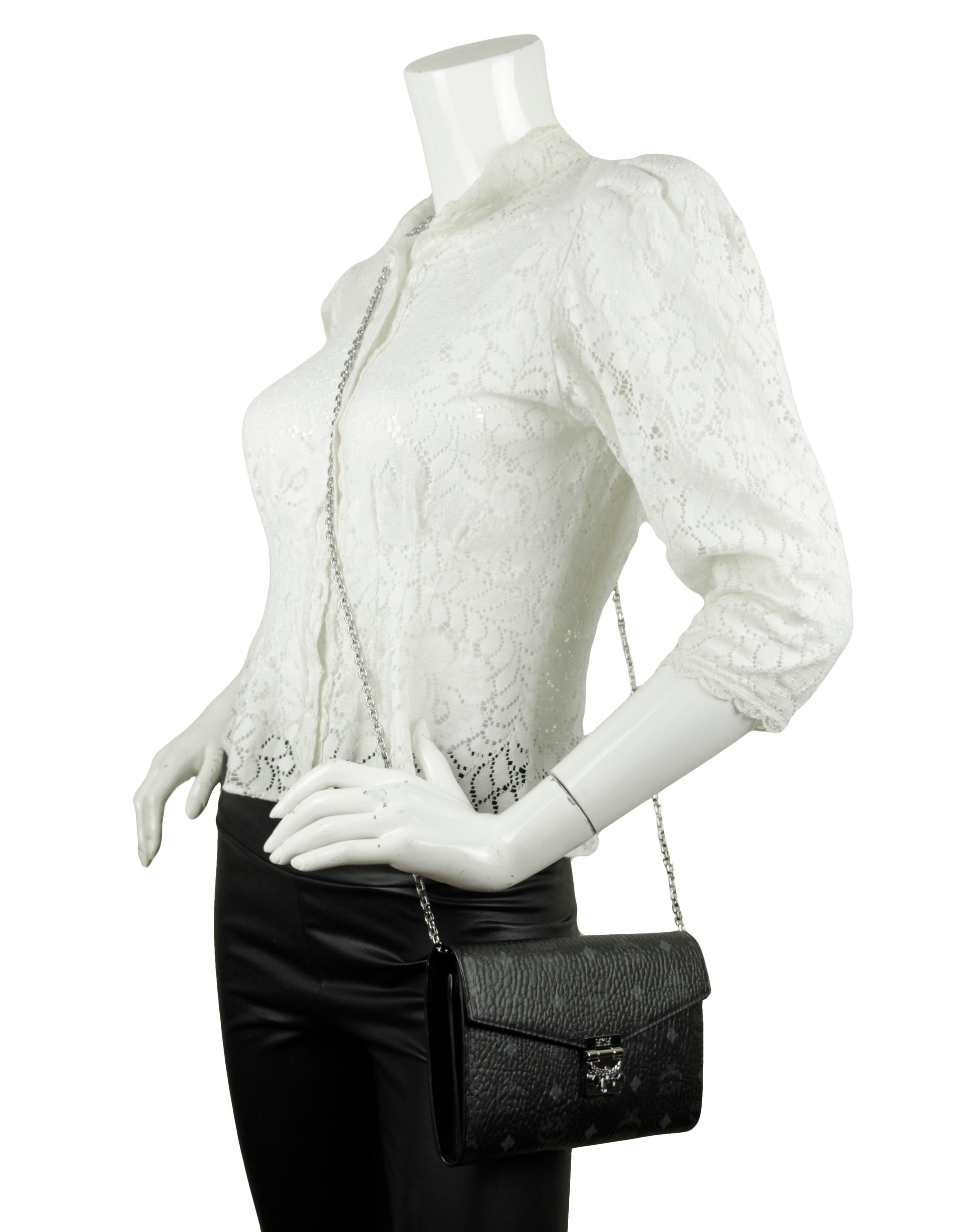MCM Black Visetos Patricia Wallet On Chain Crossbody Bag.  Features optional strap allowing for clutch or wallet wear.
Made In: Korea
Color: Black
Hardware: Silvertone
Materials: Coated canvas
Lining: Fine textile
Closure/Opening: Flap top with