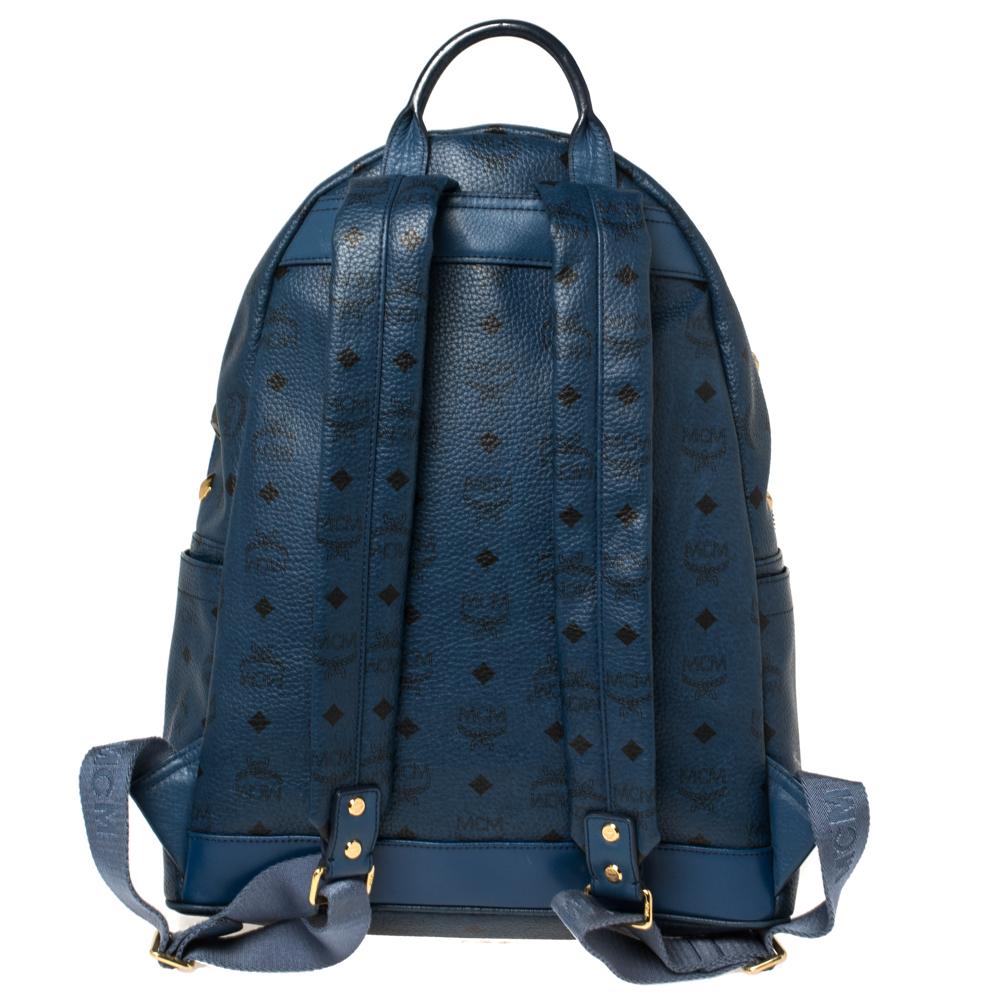 This amazing MCM backpack will come in handy for daily use or as a style statement. It is crafted from coated canvas and leather, detailed with studs, and equipped with a front pocket and a spacious interior secured by a zipper. Two shoulder straps