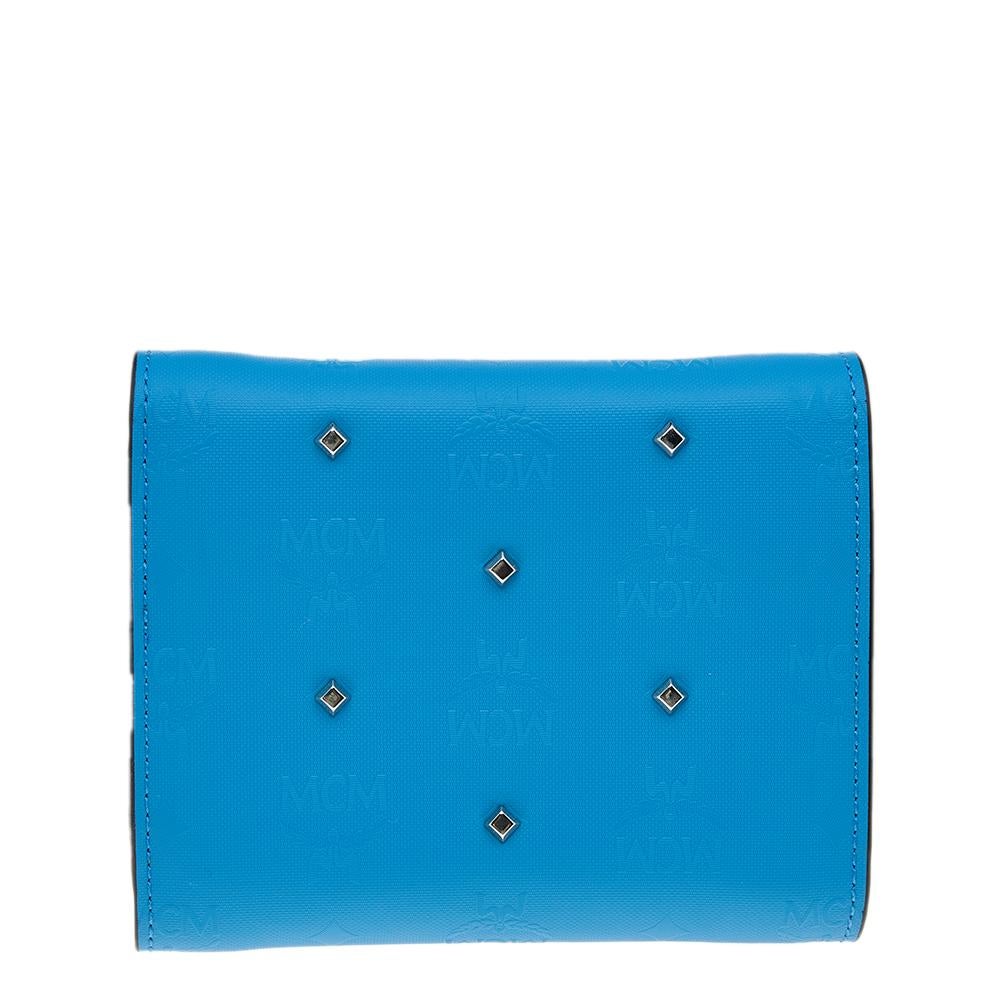 This Claudia wallet from MCM is great for everyday use. It is made from blue coated canvas on the exterior and comes with studded accents. The trifold style of this wallet opens to a leather and fabric interior. Keep all your belongings easily in