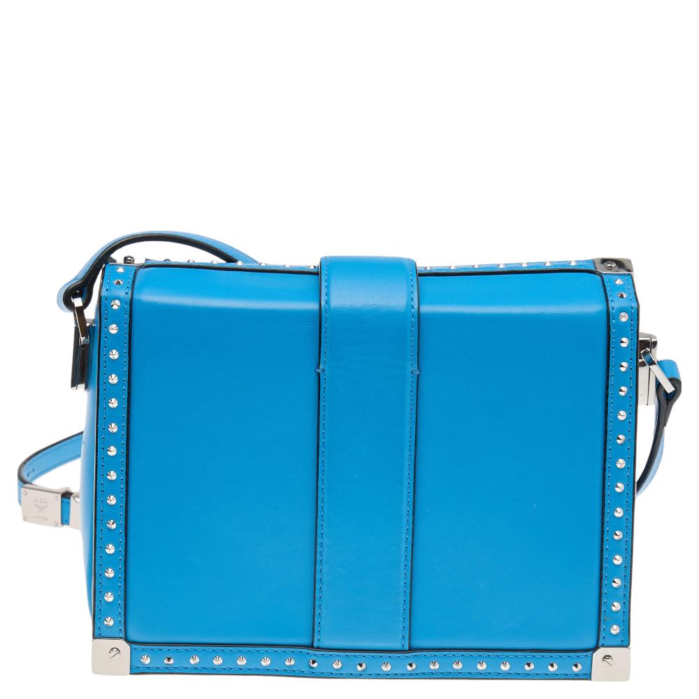 Adorned with decorative silver-tone accents on the exterior, this Box bag from MCM has a structured shape and a refined style. The bag comes crafted from blue leather and flaunts a shoulder strap. The trunk-style bag opens to a lined interior to