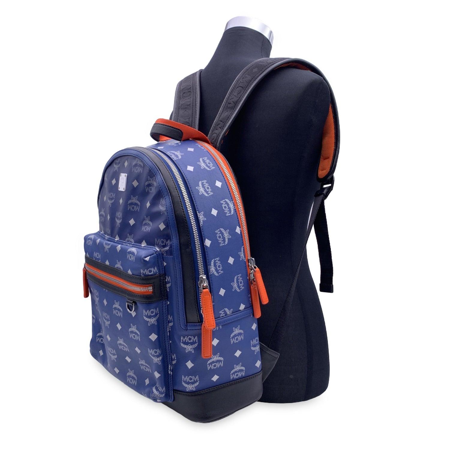 This beautiful Bag will come with a Certificate of Authenticity provided by Entrupy. The certificate will be provided at no further cost MCM Visetos Reflective Nylon Resnick Backpack in blue color with orange trim. Crafted in Monogram Visetos canvas
