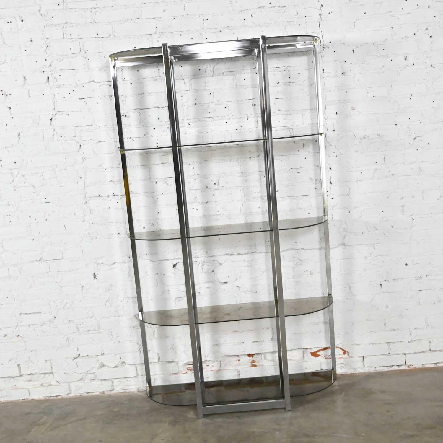 Gorgeous Mid-Century Modern étagère comprised of a bow shape chrome frame and 5 bowed smoked glass shelves. Done in the style of James David or Design Institute of America aka DIA. Beautiful condition, keeping in mind that this is vintage and not