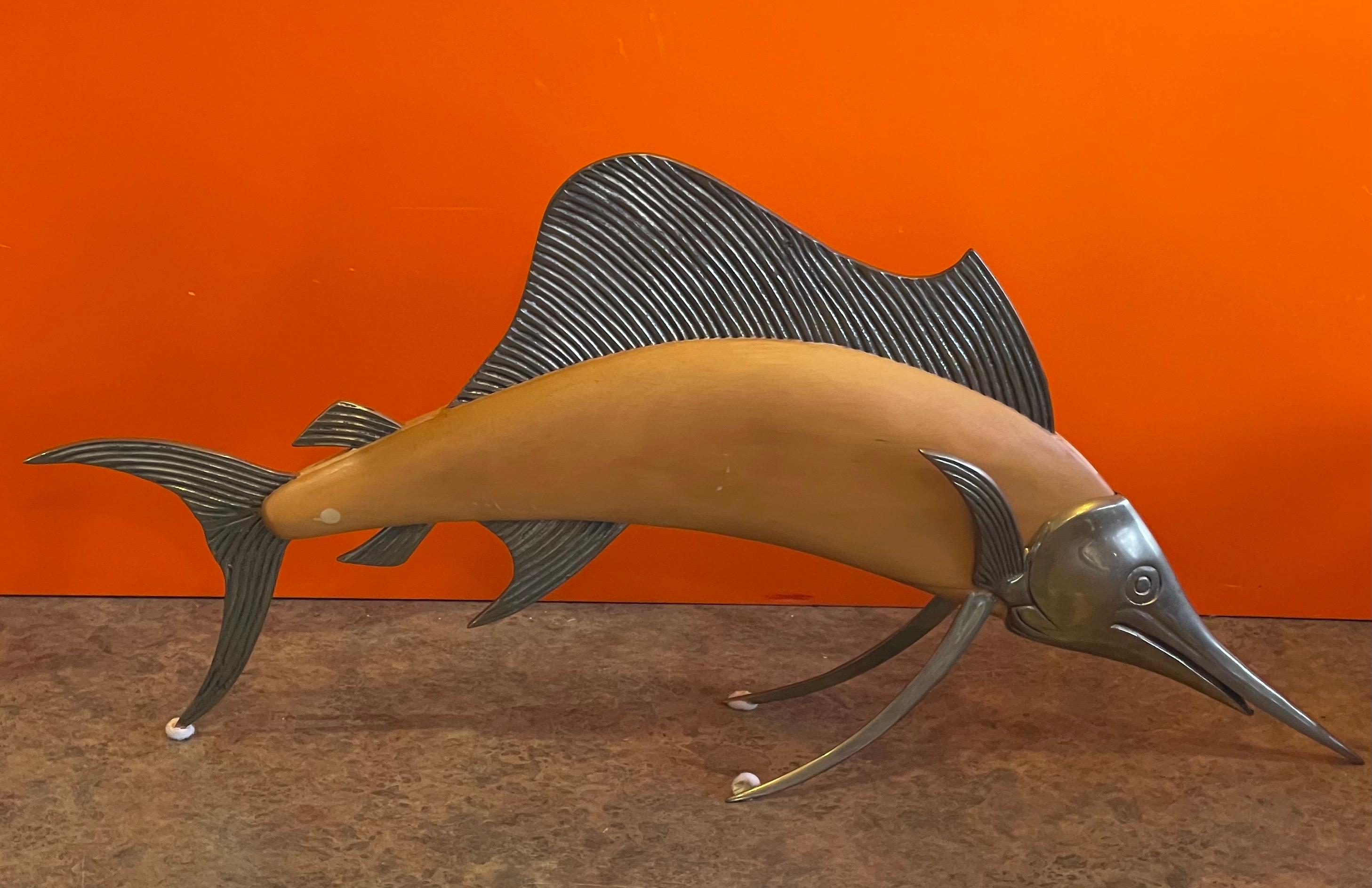 Vintage MCM large brass and light wood sailfish / marlin sculpture by Frederick Cooper, circa 1970s.  The piece is free-standing and in good vintage condition; it measures 25.5