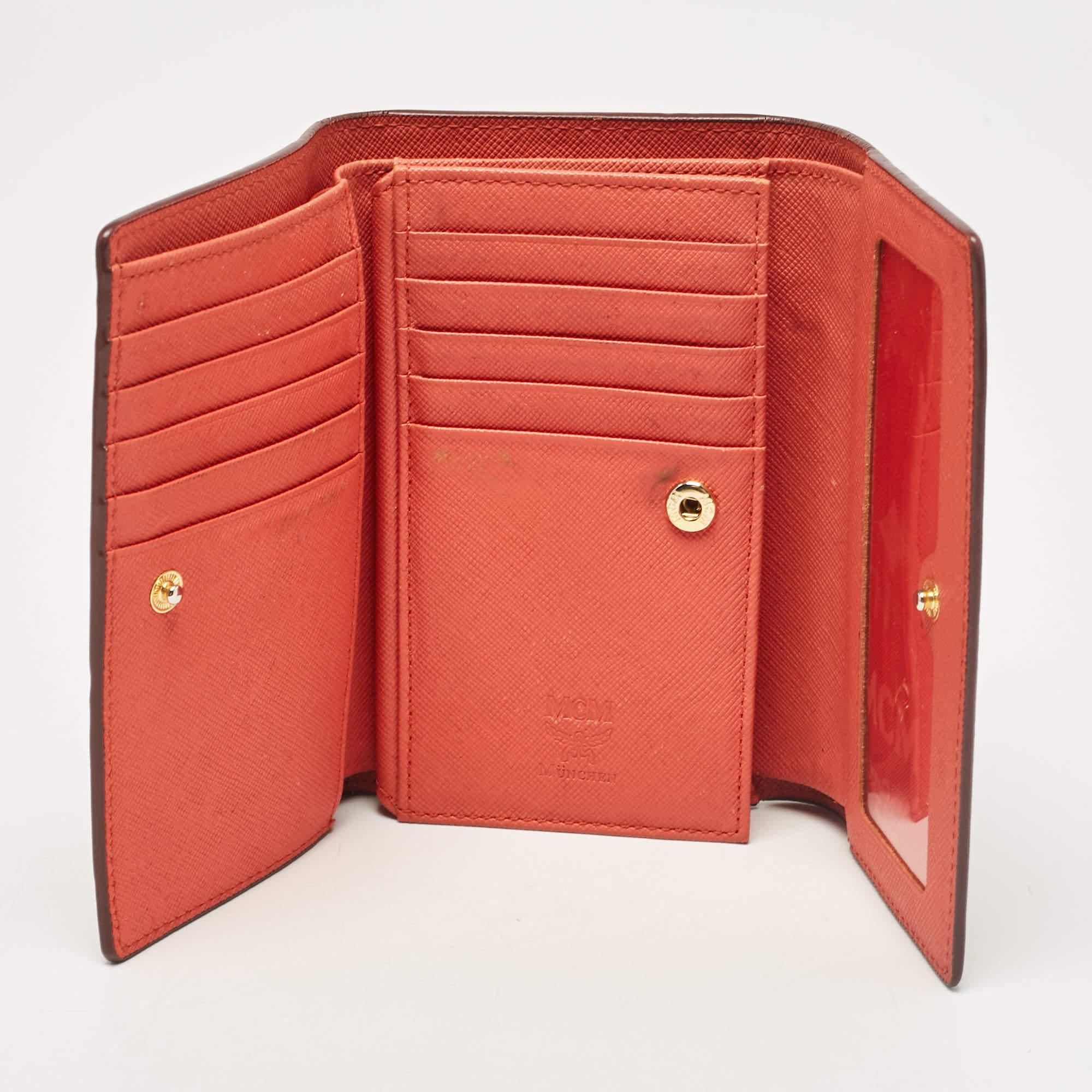 A beautiful red wallet for everyday use this MCM wallet is perfect to be carried solo or inside your tote while you step out to run errands. It is a durable accessory.