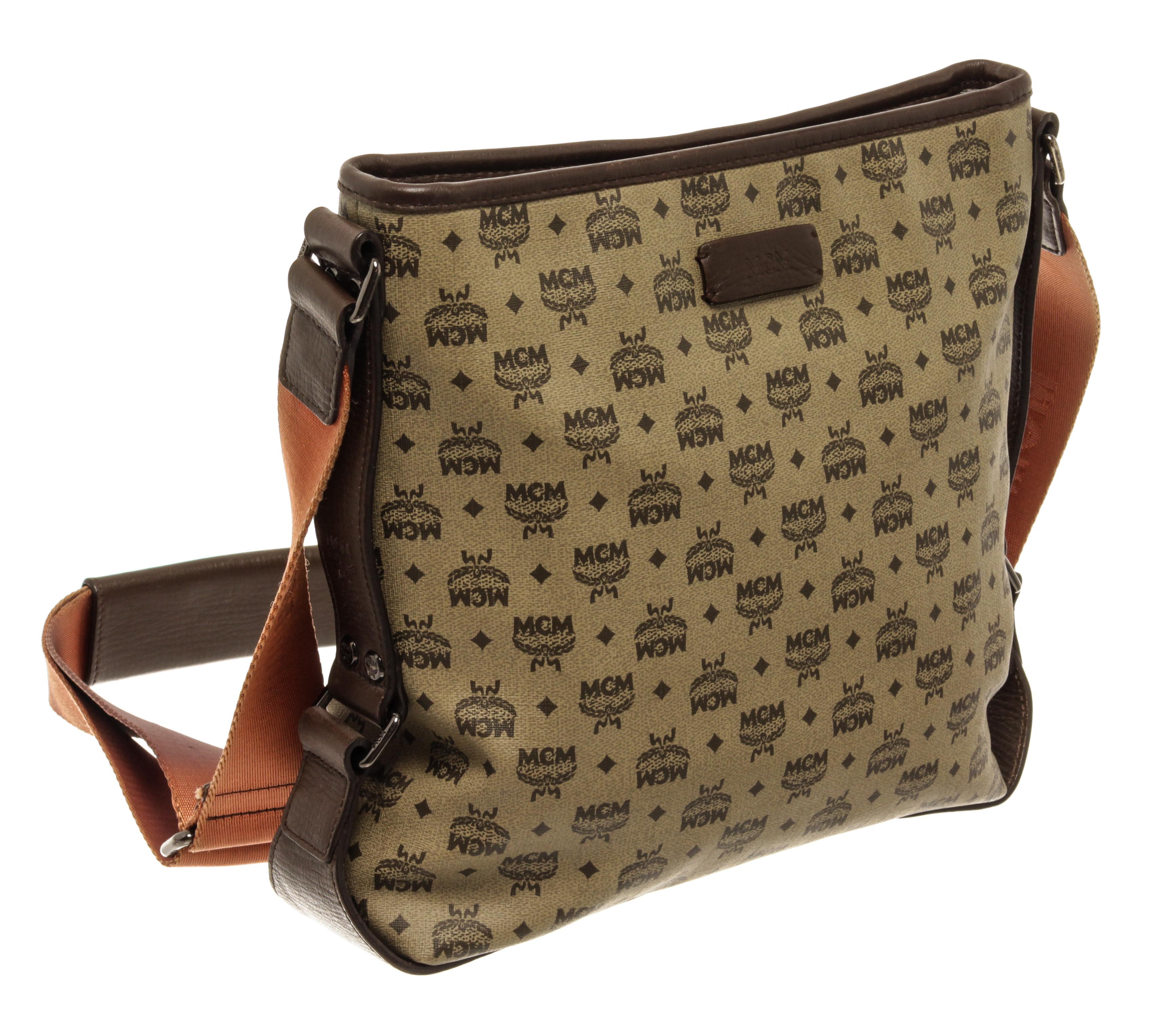 MCM Brown Visetos Coated Canvas with Pouch Crossbody Bag with The Crossbody strap can be adjusted. Has sign of usage on the handles.Has fading on the leather of the bag. Has rubbing and peeling on bottom four corners of the bags. Black sides of the