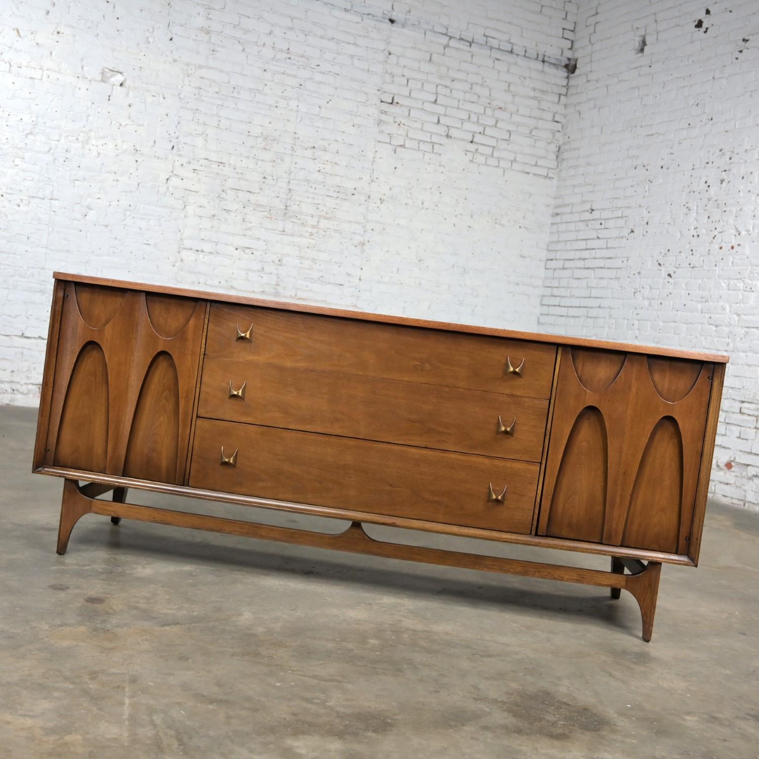 Handsome Mid-Century Modern Brutalist Brasilia Broyhill Premier Series dresser #6130-33 comprised of a walnut frame and brass hardware. Beautiful condition, keeping in mind that this is vintage and not new so will have signs of use and wear even if