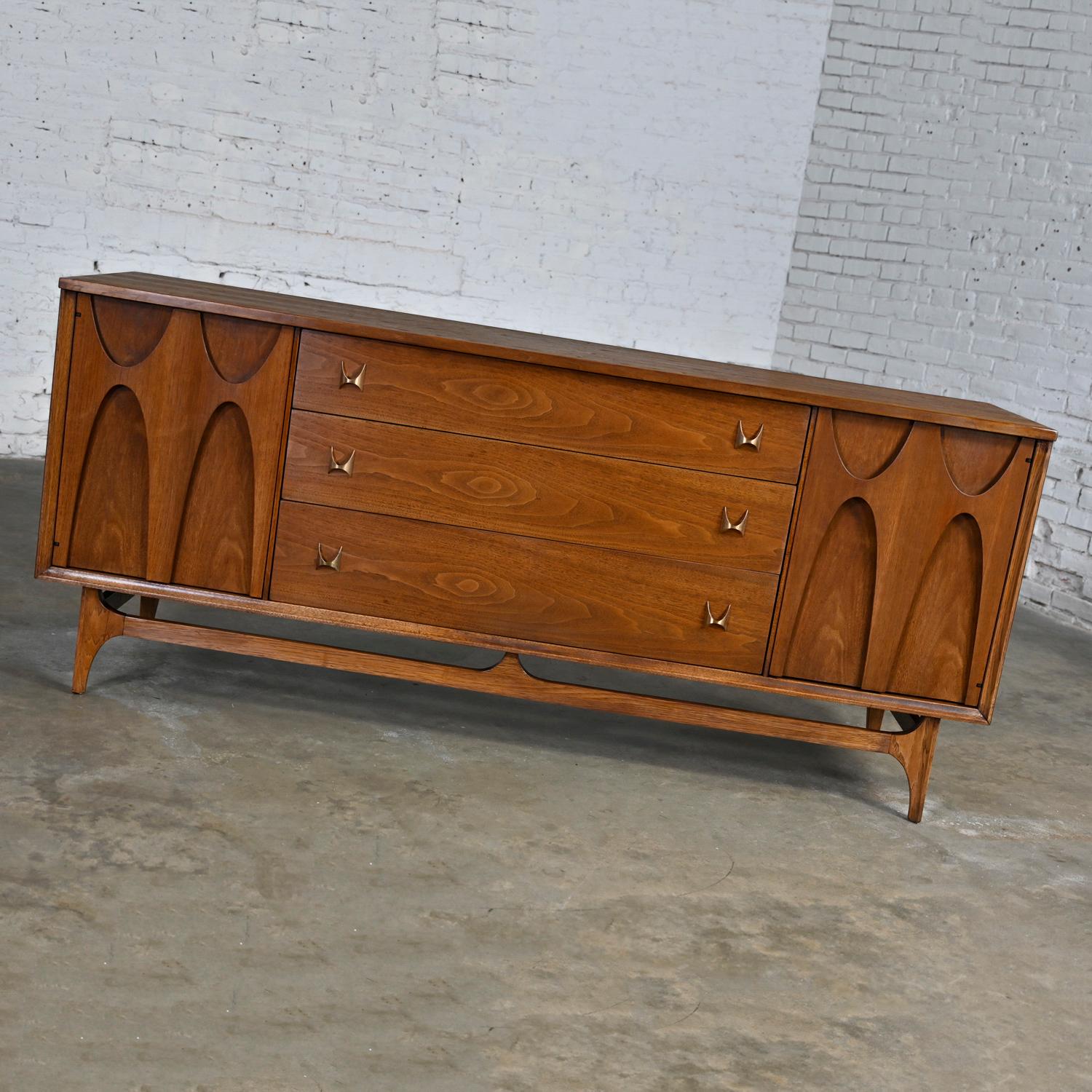 Handsome Mid-Century Modern Brutalist Brasilia dresser #6130-33 Broyhill Premier Series comprised of walnut and brass hardware. Beautiful condition, keeping in mind that this is vintage and not new so will have signs of use and wear. This piece has
