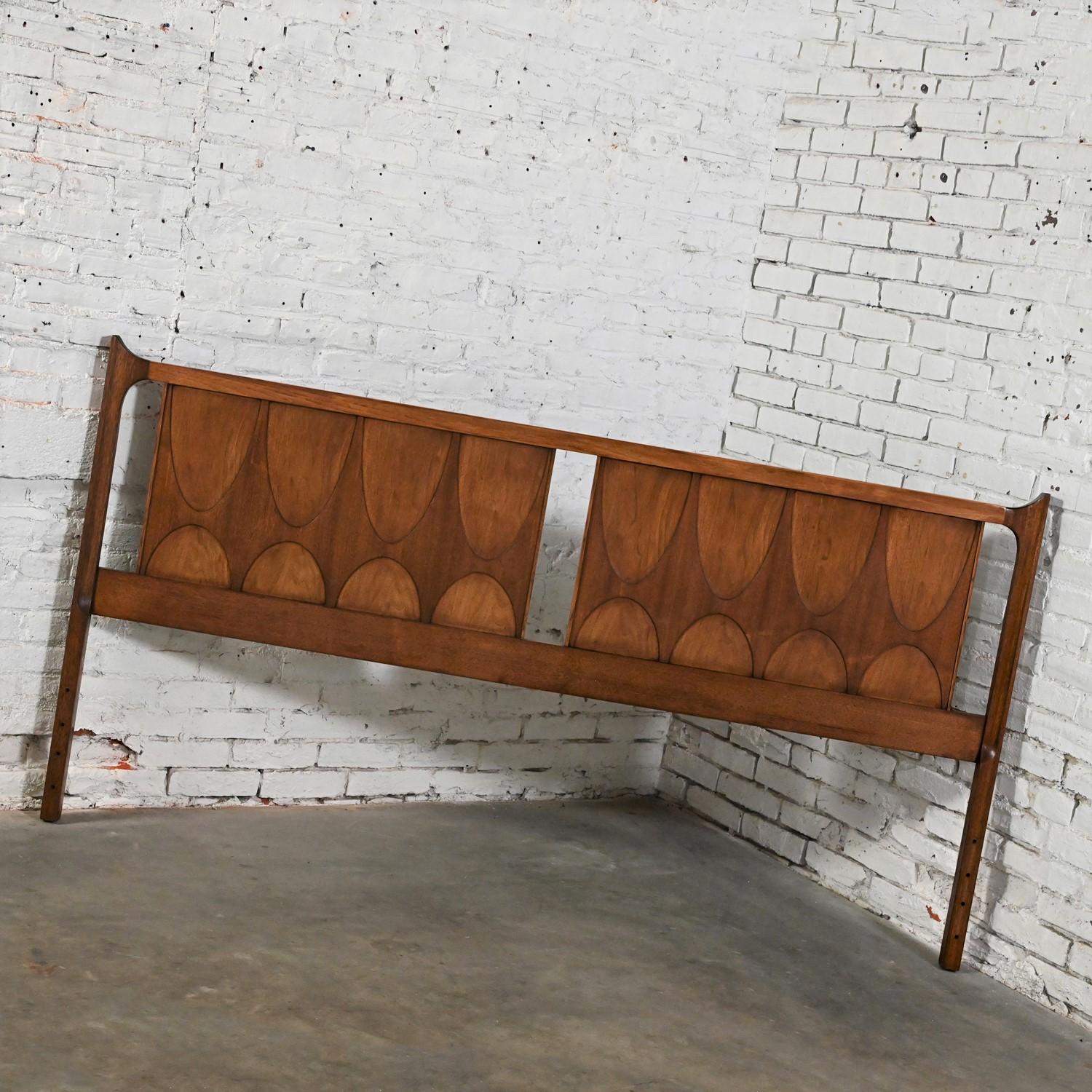 Lovely Mid-Century Modern Brutalist Brasilia king sized headboard #6130-59 Broyhill Premier Series comprised of a sculpted walnut panel.  Beautiful condition, keeping in mind that this is vintage and not new so will have signs of use and wear. This