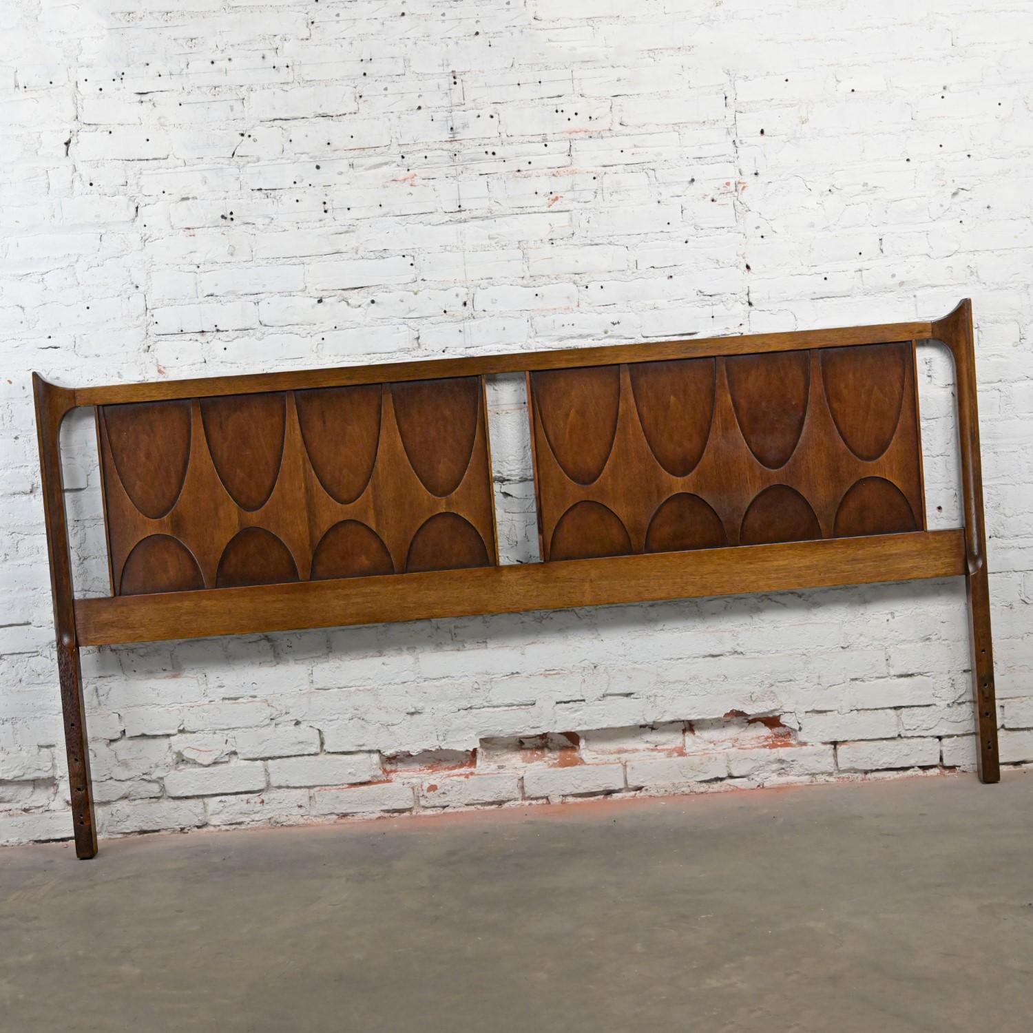 Lovely Mid-Century Modern Brutalist Broyhill Brasilia Premier Series king sized headboard #6130-59 comprised of a sculpted walnut panel. Beautiful condition, keeping in mind that this is vintage and not new so will have signs of use and wear even if