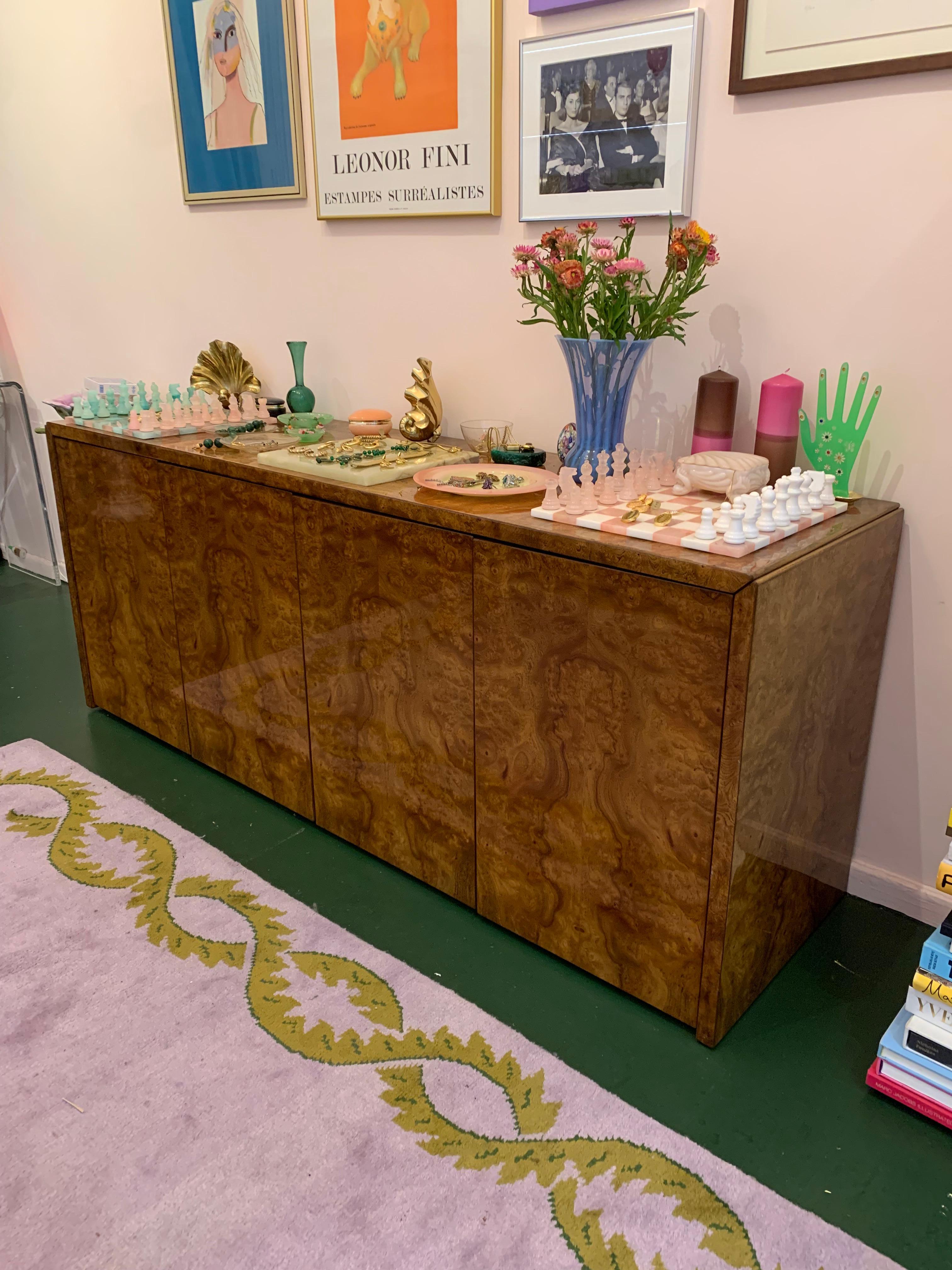 A gorgeous mid-century modern buffet or credenza. The piece has 3 compartments & 1 interior drawer. Each cabinet area has 2 wooden shelves. We've included extra shelf holders and magnetic door closures. Please note there is a hole in the back. Works