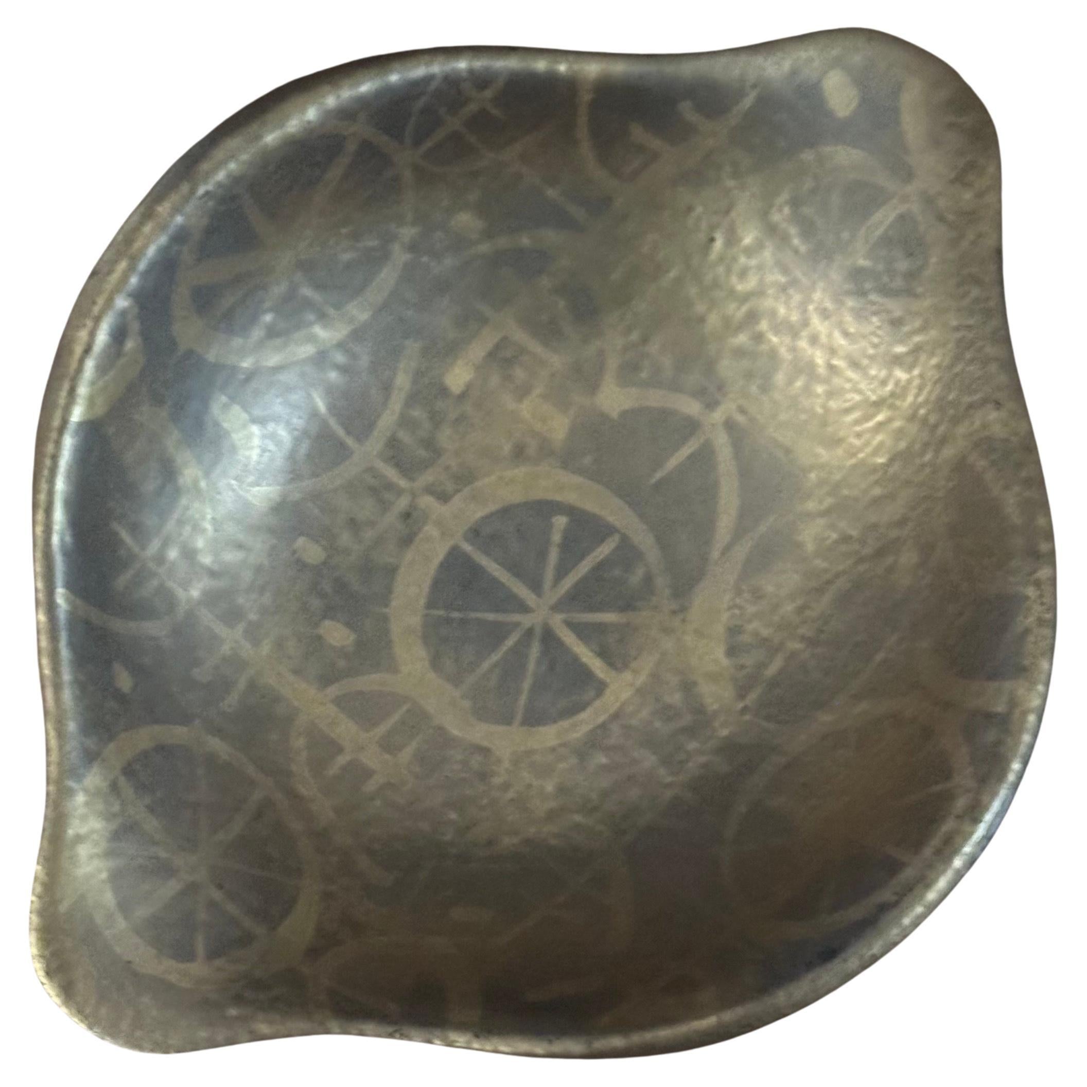 Cenicero MCM de cerámica californiana en pan de oro, obra del célebre diseñador Sascha Brastoff, hacia la década de 1970. Una pieza rara pintada a mano y firmada por Brastoff en la parte inferior. Sería un complemento maravilloso para cualquier