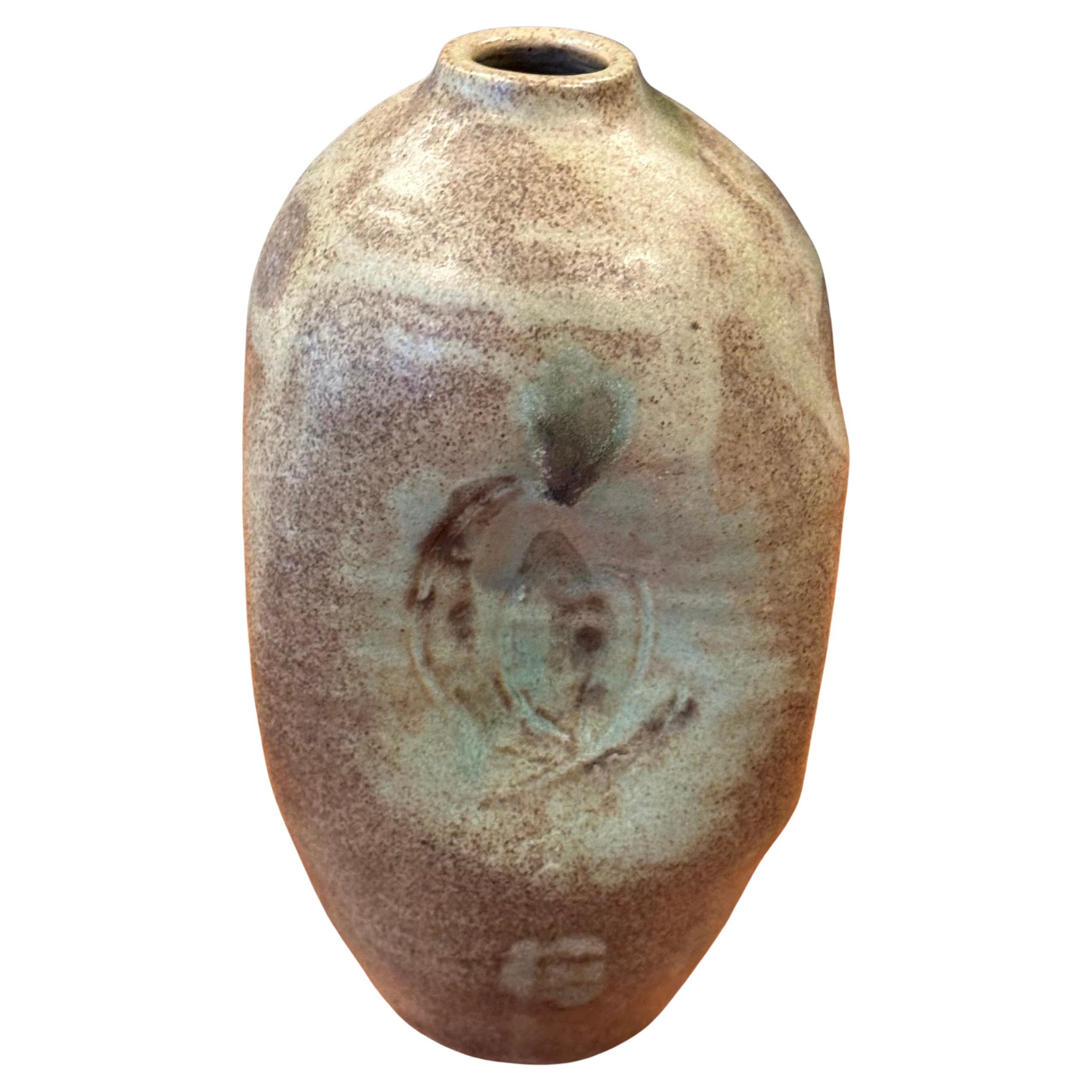 A very nice MCM California studio pottery stoneware vase with brown and green earth tones and pinched sides, circa 1966. The vessel is in very good vintage condition with no chips or cracks and measures 4.5