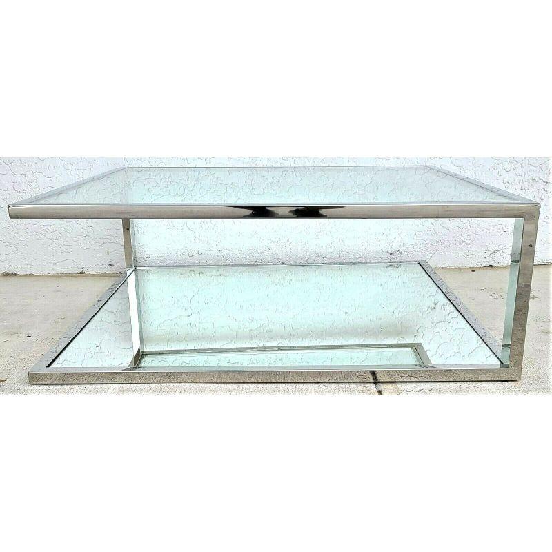 Italian Mid-Century Modern chrome glass & mirror floating top coffee table.

Featuring a thick glass insert at top and thick mirrored insert on the base. Top has only 2 corner supports creating a floating top look.

Approximate Measurements in