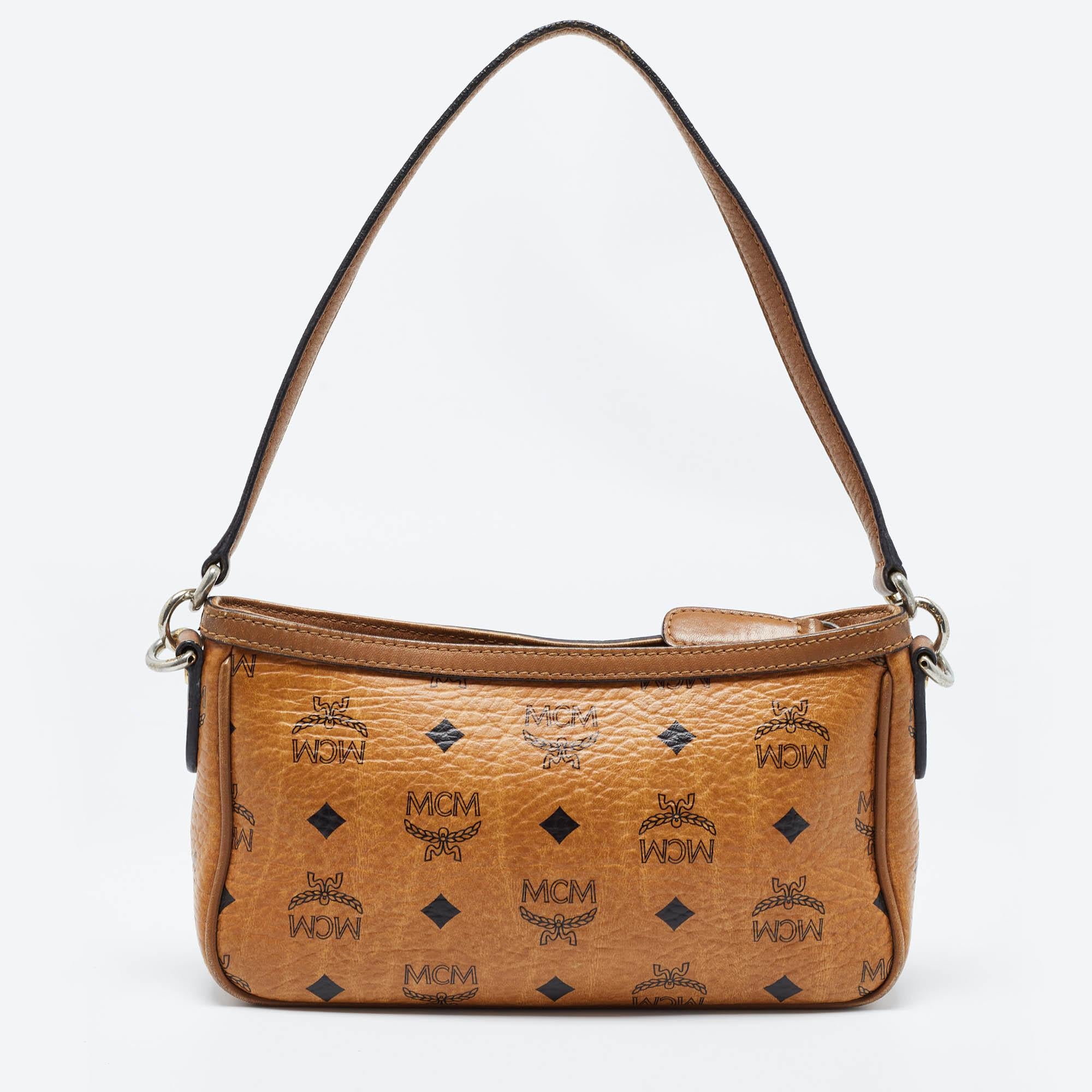 This MCM shoulder bag showcases the label's classy design attributes. It is made from Visetos coated canvas and added with a zip closure and a top handle.

