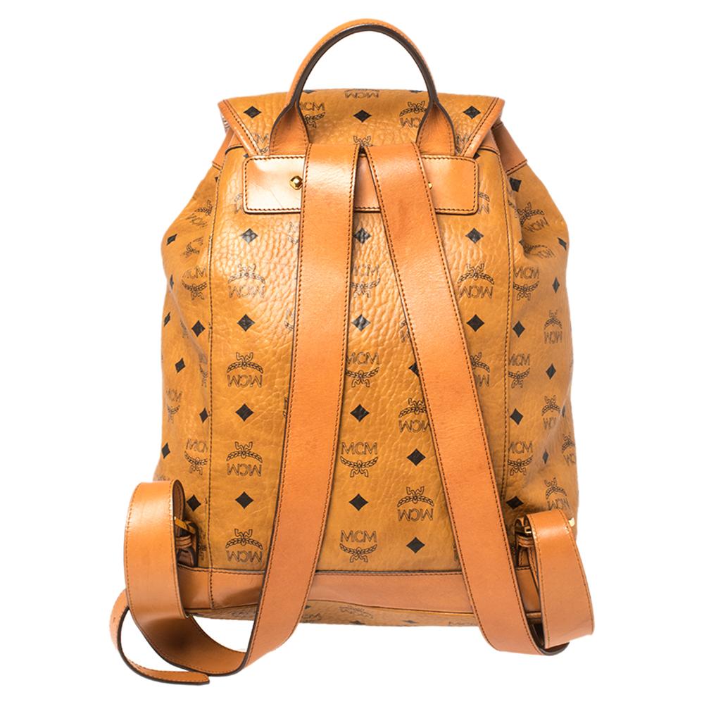 This stunning MCM backpack will come in handy for daily use or as a style statement. It is crafted from Visetos coated canvas & leather and designed with a front pocket and a spacious interior secured by a flap and a drawstring closure. Two shoulder
