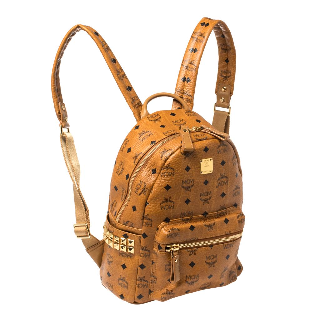 This MCM backpack will come in handy for daily use or as a style statement. It is crafted from Visetos coated canvas and designed with a front pocket, stud detailing and a spacious interior secured by a zipper. Two shoulder straps and a small top