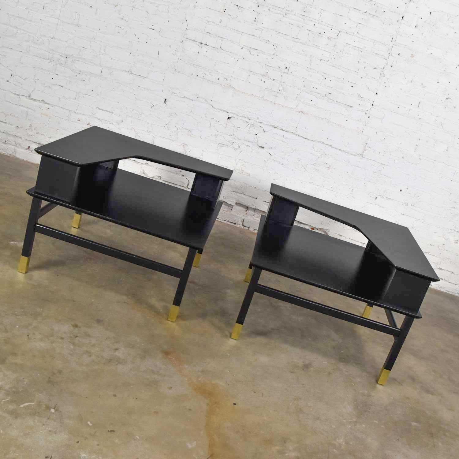 Wonderful pair of vintage Mid-Century Modern (MCM) corner step tables in the style of Harvey Prober. Comprised of hardwood, brass sabots, and painted matte black finish. Gorgeous condition. This pair of tables have been completely restored to their