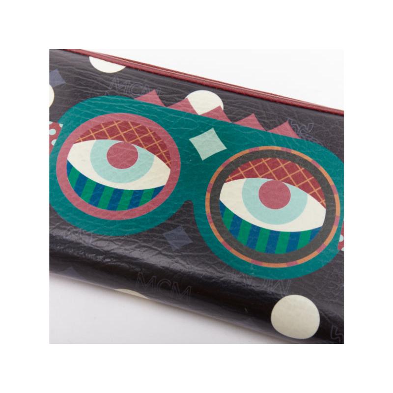 De las mujeres Cartera larga con cremallera MCM CRAIG KARL Beyond Snowdome de piel negra con ojo gráfico en venta