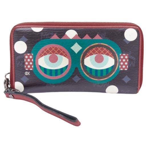 Cartera larga con cremallera MCM CRAIG KARL Beyond Snowdome de piel negra con ojo gráfico en venta