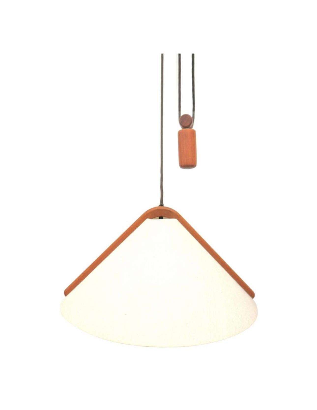 A very cool and rare MCM Danish modern adjustable teak pendant lamp with counterweight by Domus, circa 1970s. The lamp is in very good vintage condition and measures 23.5