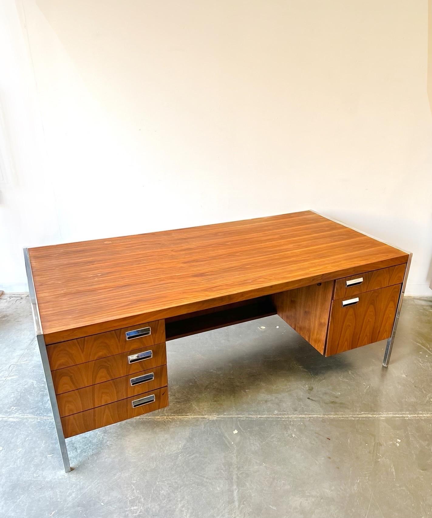 Gorgeous walnut and chrome executive office desk.

In the manner of a Florence knoll design this piece is in great condition with a refinished top.