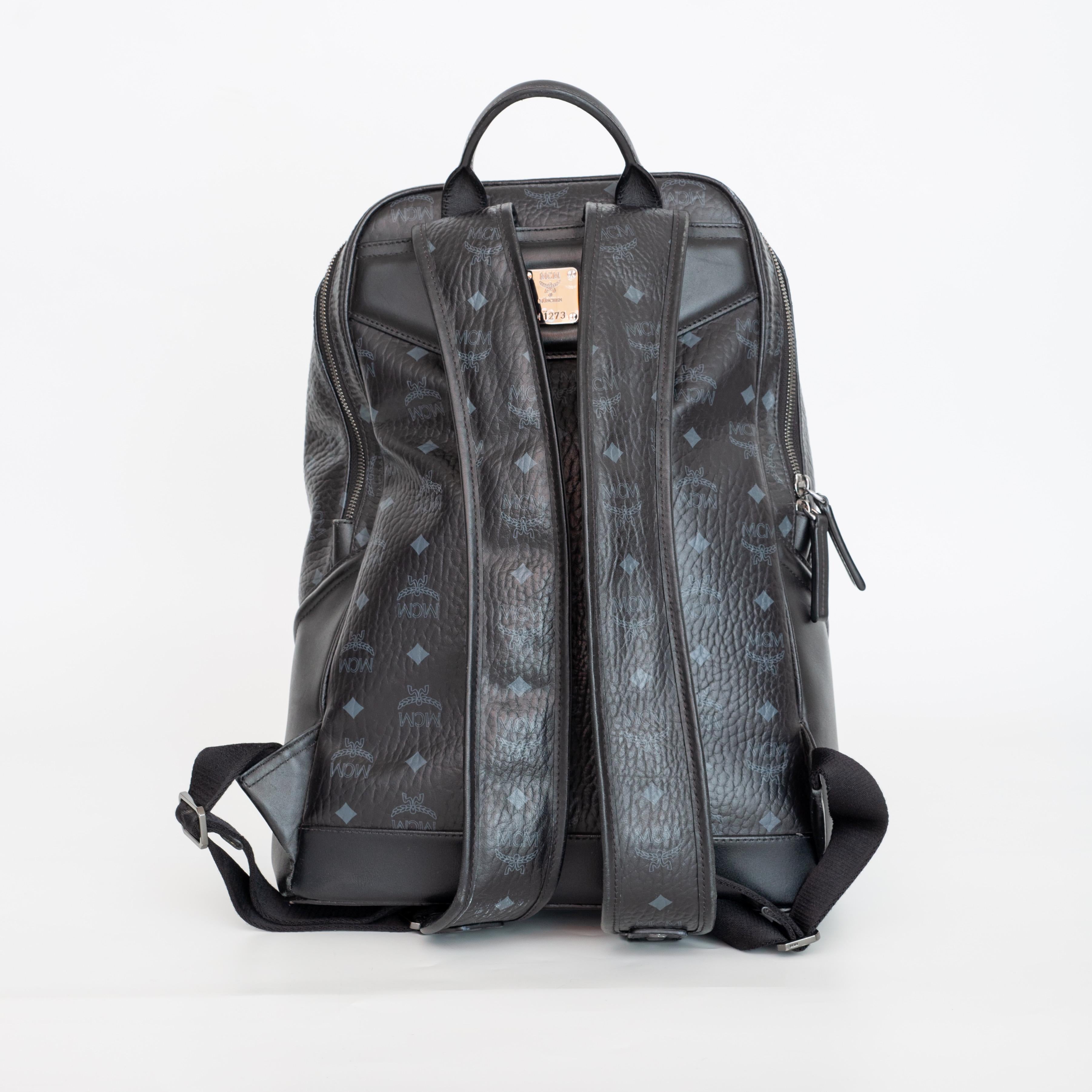 This backpacks features a coated canvas exterior, a leather top handle with leather trim and detail, adjustable shoulder straps, reinforced leather bottom corners, two-way zip-around back compartment, zip-around front gusset compartment, interior