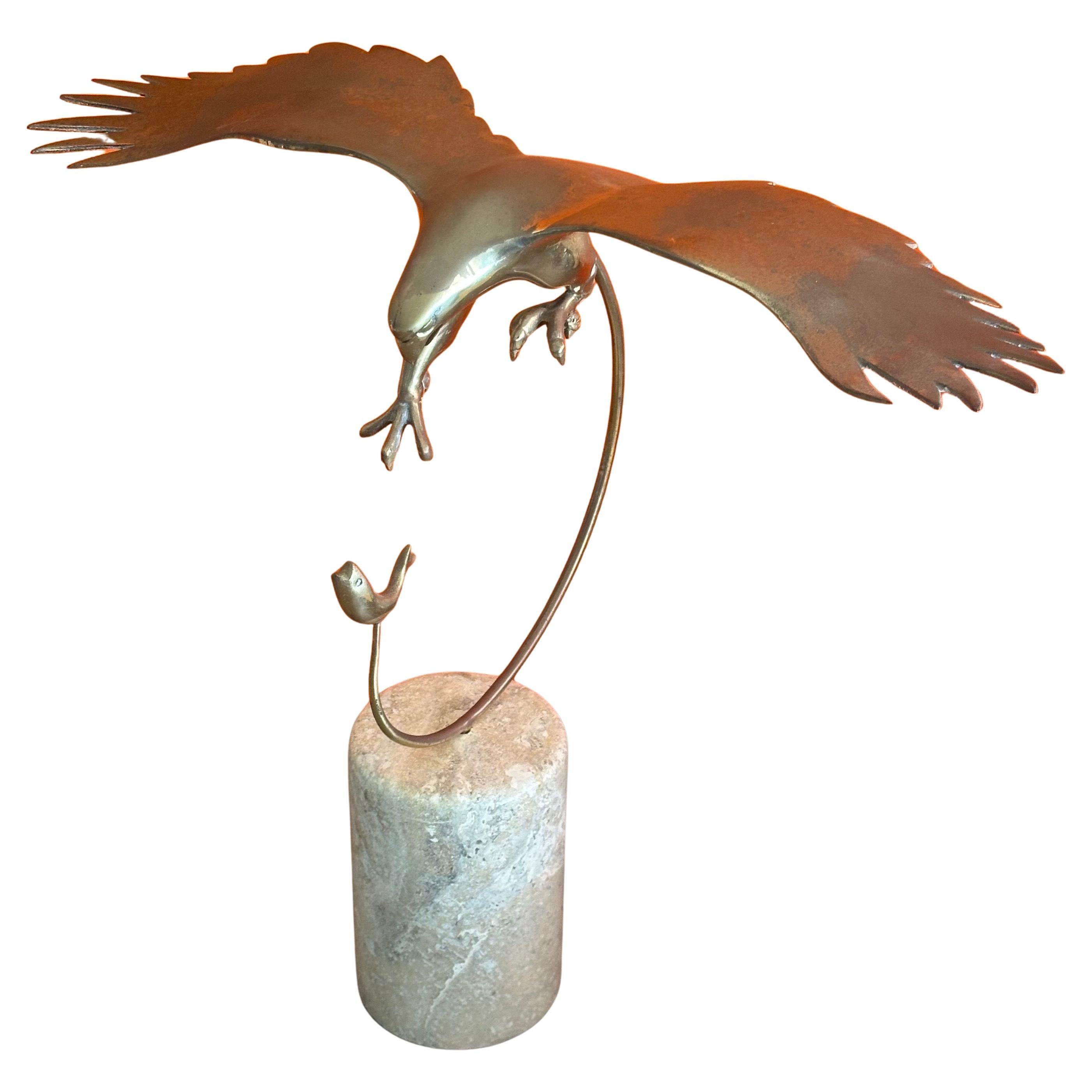 Beautiful patinated MCM eagle catching a fish brass sculpture on marble base by Bijian, circa 1970s.  The sculpture sits on a marble column measuring 4